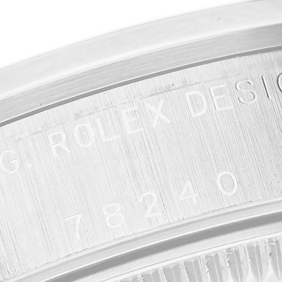 The image shows a close-up of the case back and serial engraving of a Rolex Mid-Size 78240 Women's Stainless Steel White Dial 78240 Women's Stainless Steel White Dial model watch.