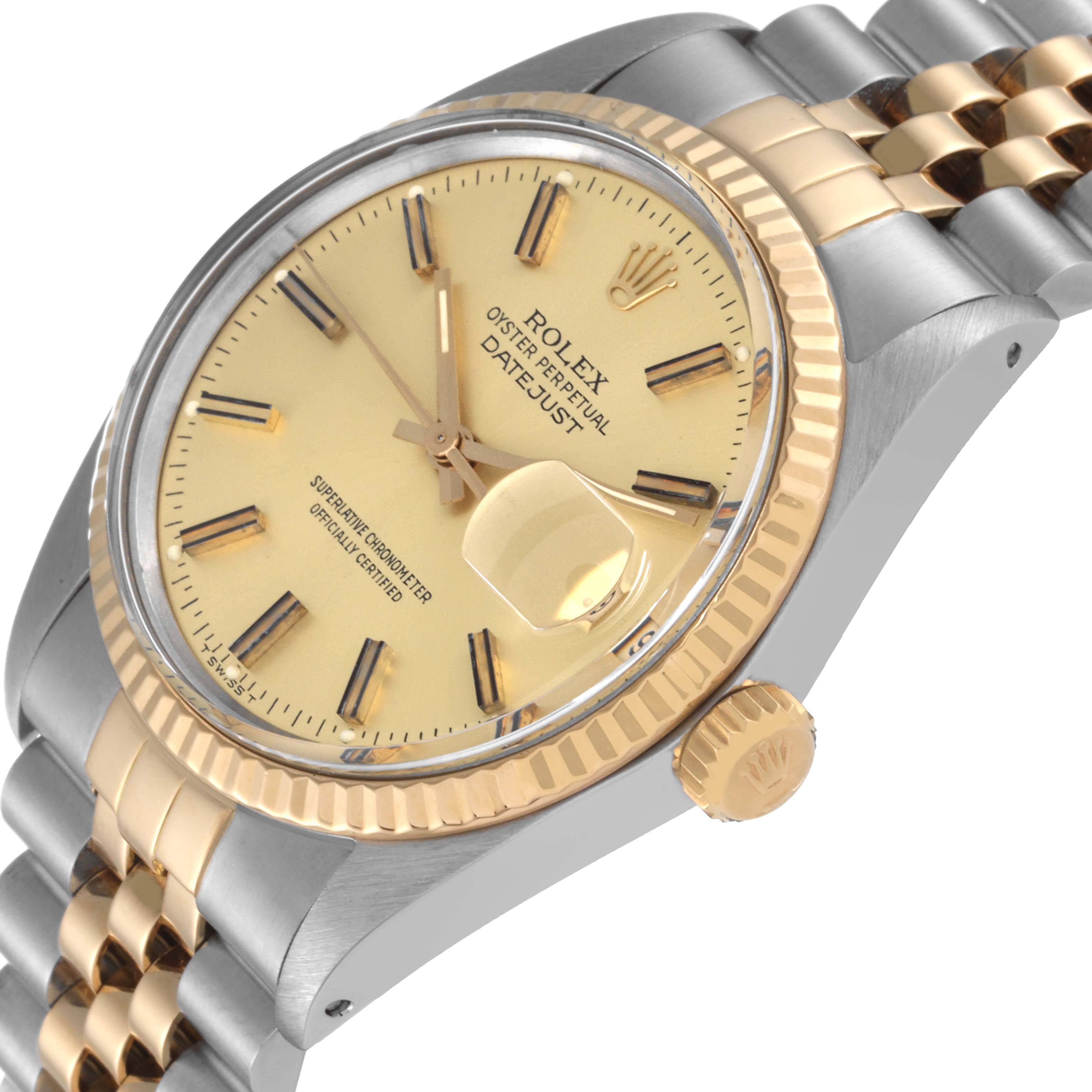 This image shows the dial, fluted bezel, and part of the bracelet of the Rolex Datejust 16013 Men's Steel and Gold (two tone) Champagne Dial 16013 Men's Steel and Gold (two tone) Champagne Dial watch at an angled perspective.