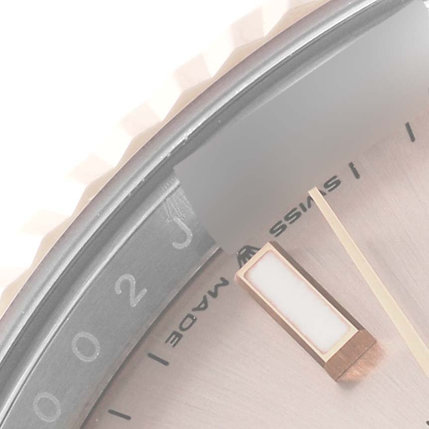 The image shows a close-up view of the Rolex Datejust 41 126331 Men's Steel and Gold (two tone) Pink Dial 126331 Men's Steel and Gold (two tone) Pink Dial watch dial, specifically the indices, part of the bezel, and the "Swiss Made" text.