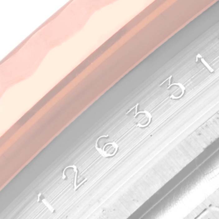 This image shows a close-up of the bezel and date indicator of a Rolex Datejust 41 126331 Men's Steel and Gold (two tone) Pink Dial 126331 Men's Steel and Gold (two tone) Pink Dial watch.