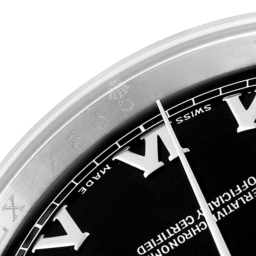 This image shows a close-up angle of the Rolex Datejust 116200 Men's Stainless Steel Black Dial 116200 Men's Stainless Steel Black Dial watch's bezel and part of the dial, revealing the Roman numeral markers.