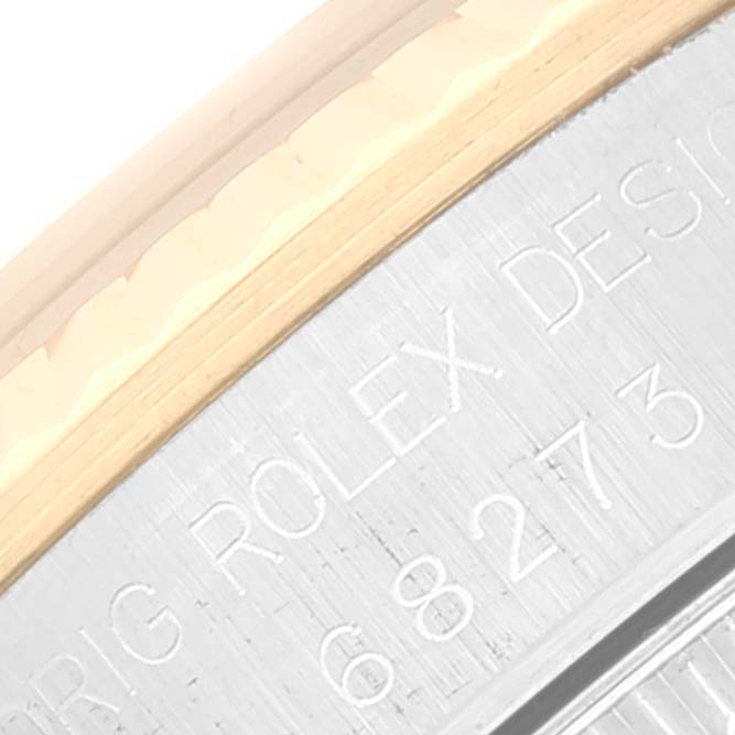 This close-up shows the side engraving of a Mid-Size Rolex watch bezel and case.