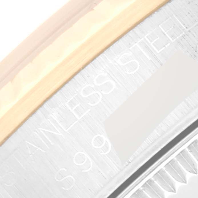 This image shows a close-up of the side of the bezel and case, highlighting the engraving and materials of the Rolex Mid-Size 68273 Women's Steel and Gold (two tone) Champagne Dial 68273 Women's Steel and Gold (two tone) Champagne Dial model.