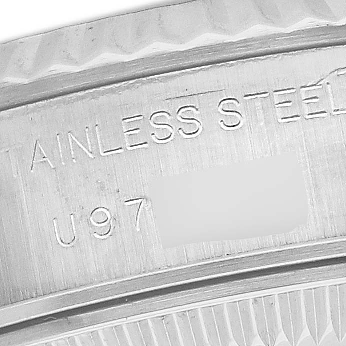 This is a close-up view of the serial number and stainless steel engraving on the case back of a Rolex Datejust 69174G Women's Stainless Steel Silver Dial 69174G Women's Stainless Steel Silver Dial watch.