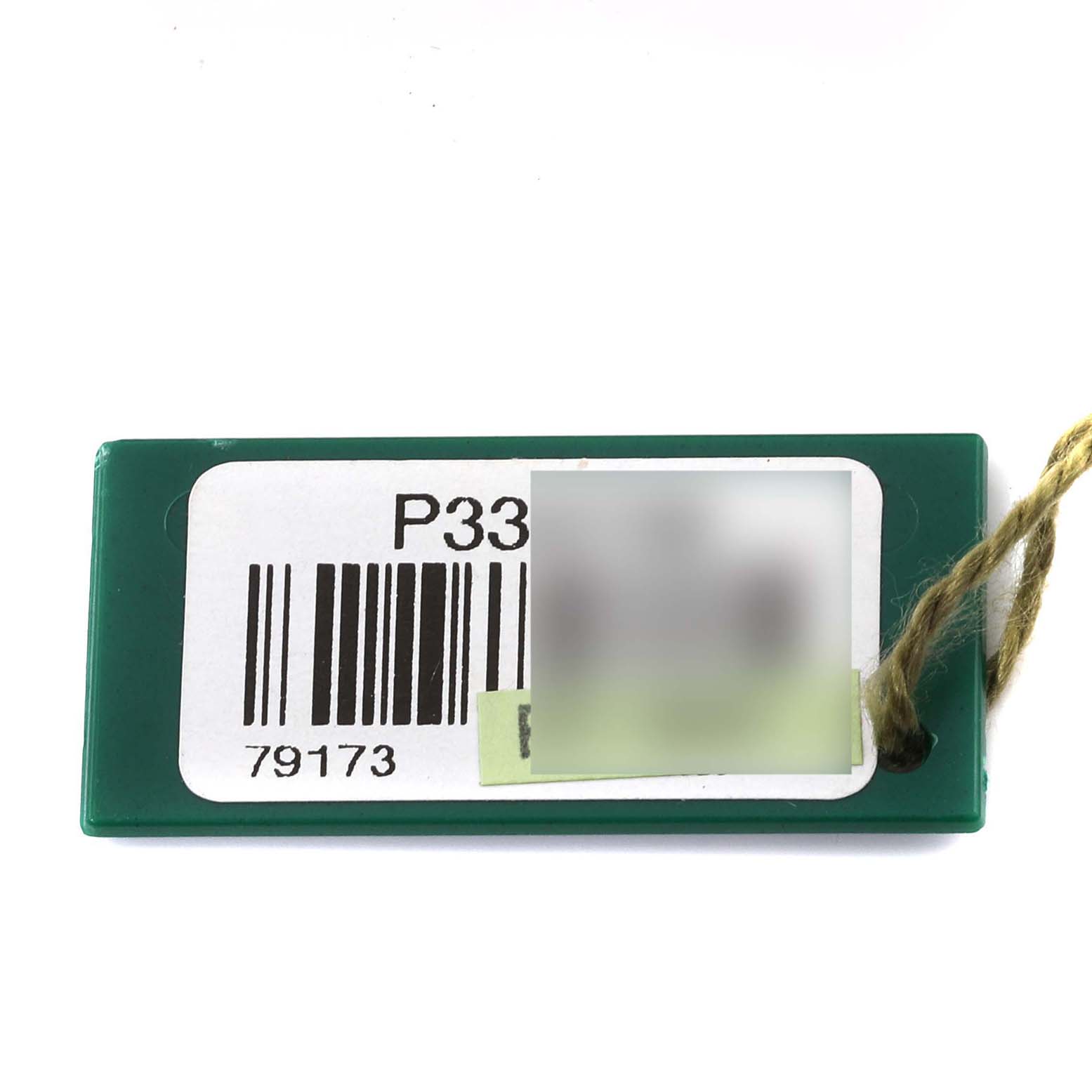 The image shows a green Rolex Datejust 79173 Women's Steel and Gold (two tone) Silver Dial 79173 Women's Steel and Gold (two tone) Silver Dial tag with a barcode and model number on it.