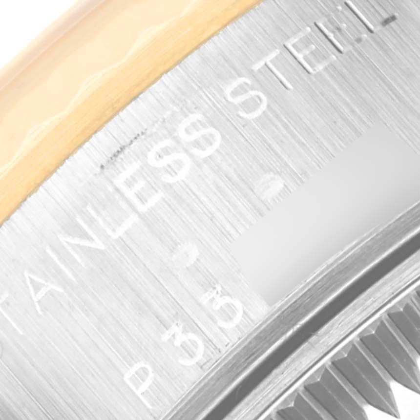 The image shows a close-up view of the side bezel and part of the engraving on a Rolex Datejust 79173 Women's Steel and Gold (two tone) Silver Dial 79173 Women's Steel and Gold (two tone) Silver Dial watch, highlighting the stainless steel material.