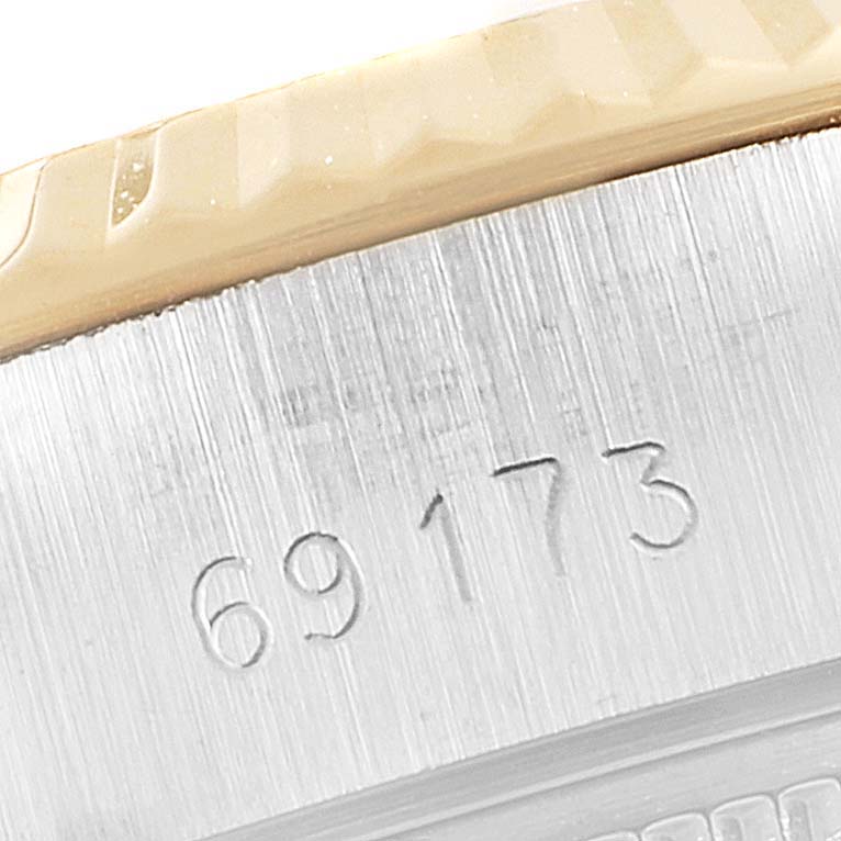 The image shows a close-up of the side of a Rolex Datejust 69173 Women
s Steel and Gold (two tone) Silver Dial 69173 Women
s Steel and Gold (two tone) Silver Dial watch model 69173, highlighting the watch
s case and engraved reference number.