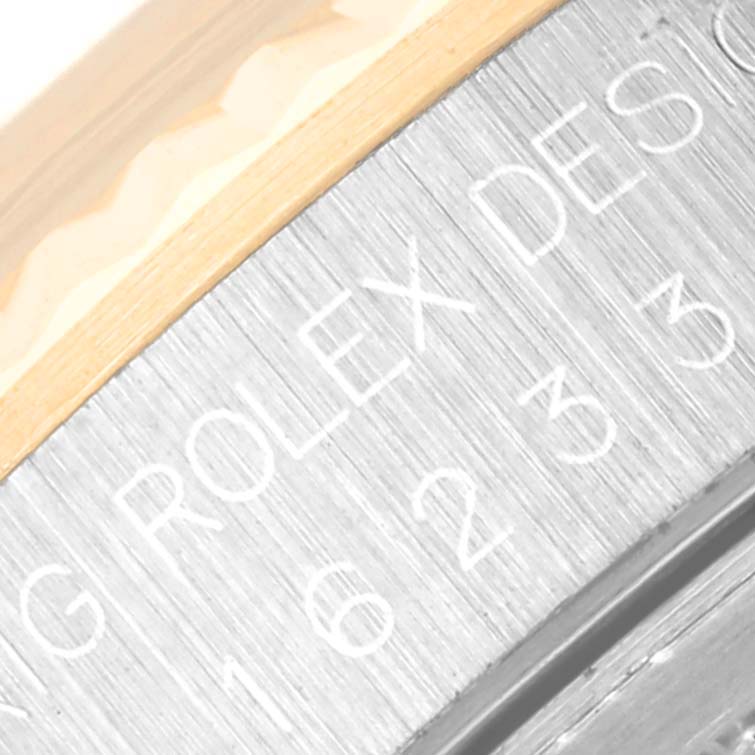 This close-up image shows the engraved model number and bezel edge of the Rolex Datejust 16233 Men
s Steel and Gold (two tone) Grey Dial 16233 Men
s Steel and Gold (two tone) Grey Dial watch.