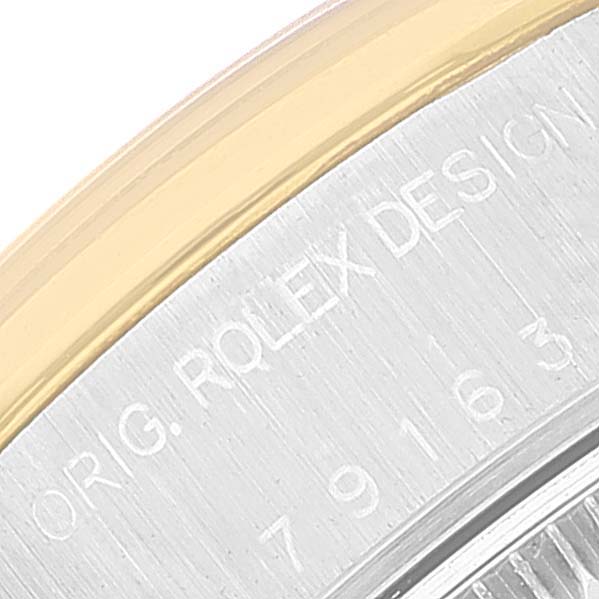 The image shows a close-up of the side engraving on the Rolex Datejust 79163 Women's Steel and Gold (two tone) Silver Dial 79163 Women's Steel and Gold (two tone) Silver Dial watch case, highlighting the bezel and part of the case.