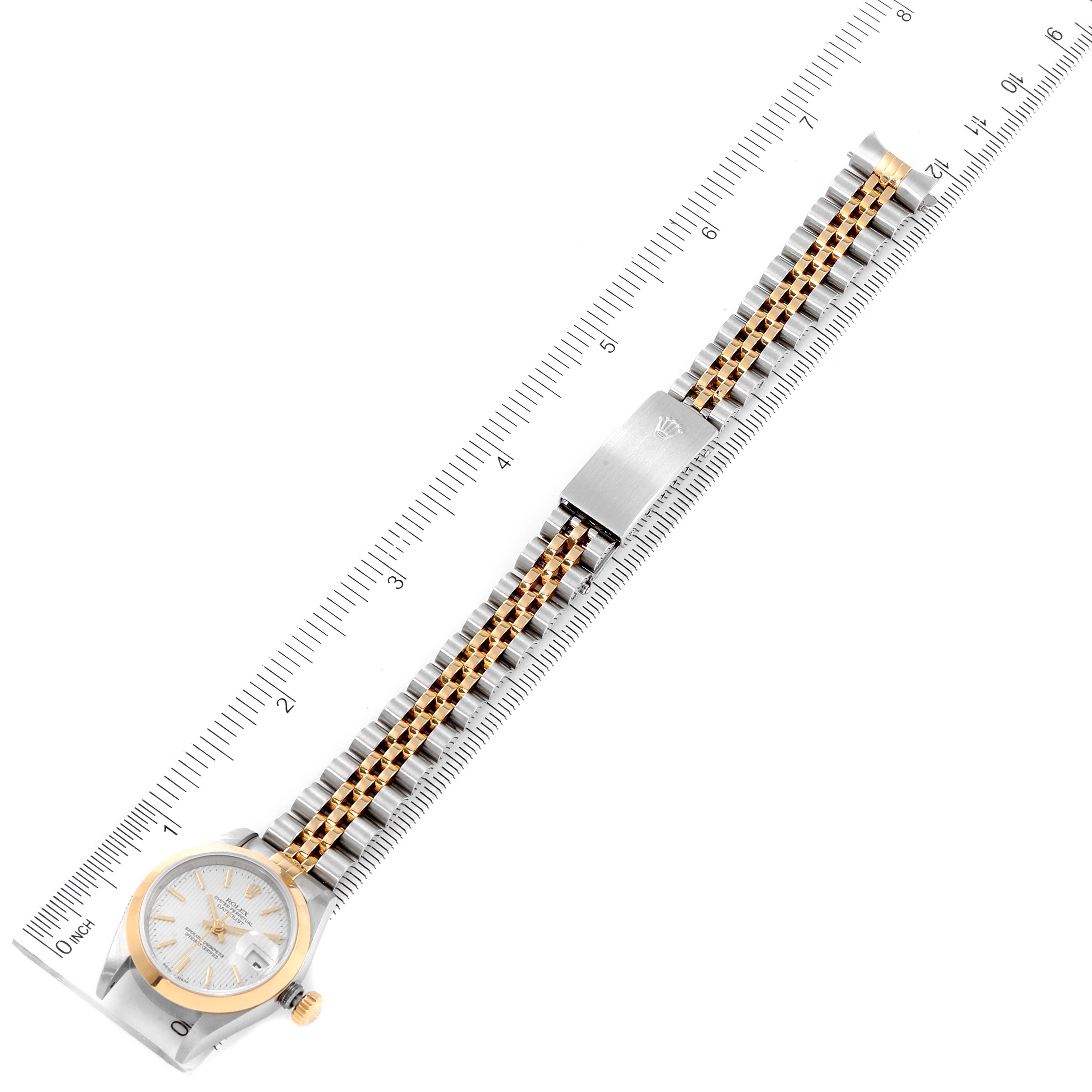 The image shows a top-down view of a Rolex Datejust 79163 Women's Steel and Gold (two tone) Silver Dial 79163 Women's Steel and Gold (two tone) Silver Dial watch with its bracelet extended and aligned along a ruler.