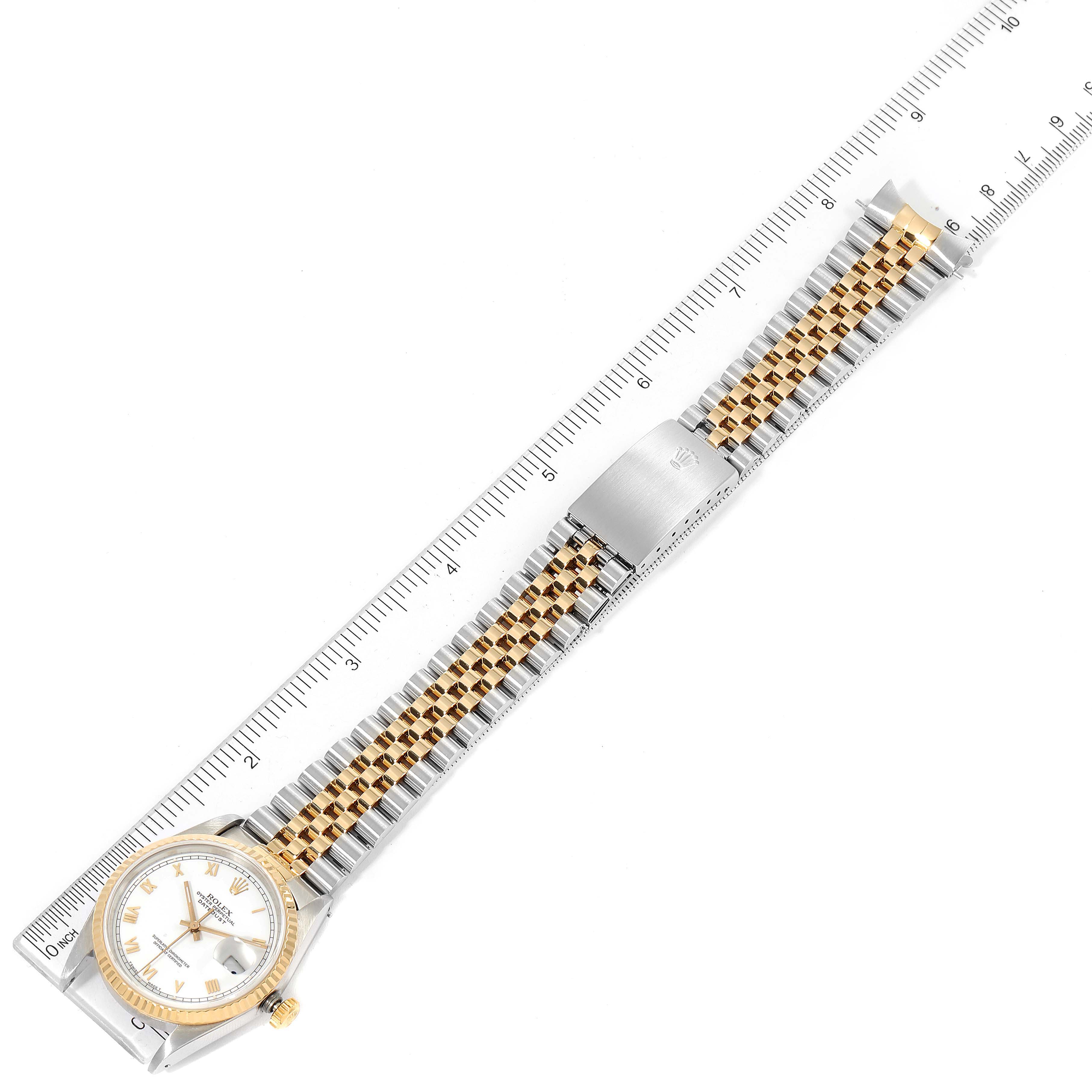 The image shows a Rolex Datejust 16233 Men's Steel and Gold (two tone) White Dial 16233 Men's Steel and Gold (two tone) White Dial watch laid flat with its bracelet extended, parallel to a ruler for measurement.