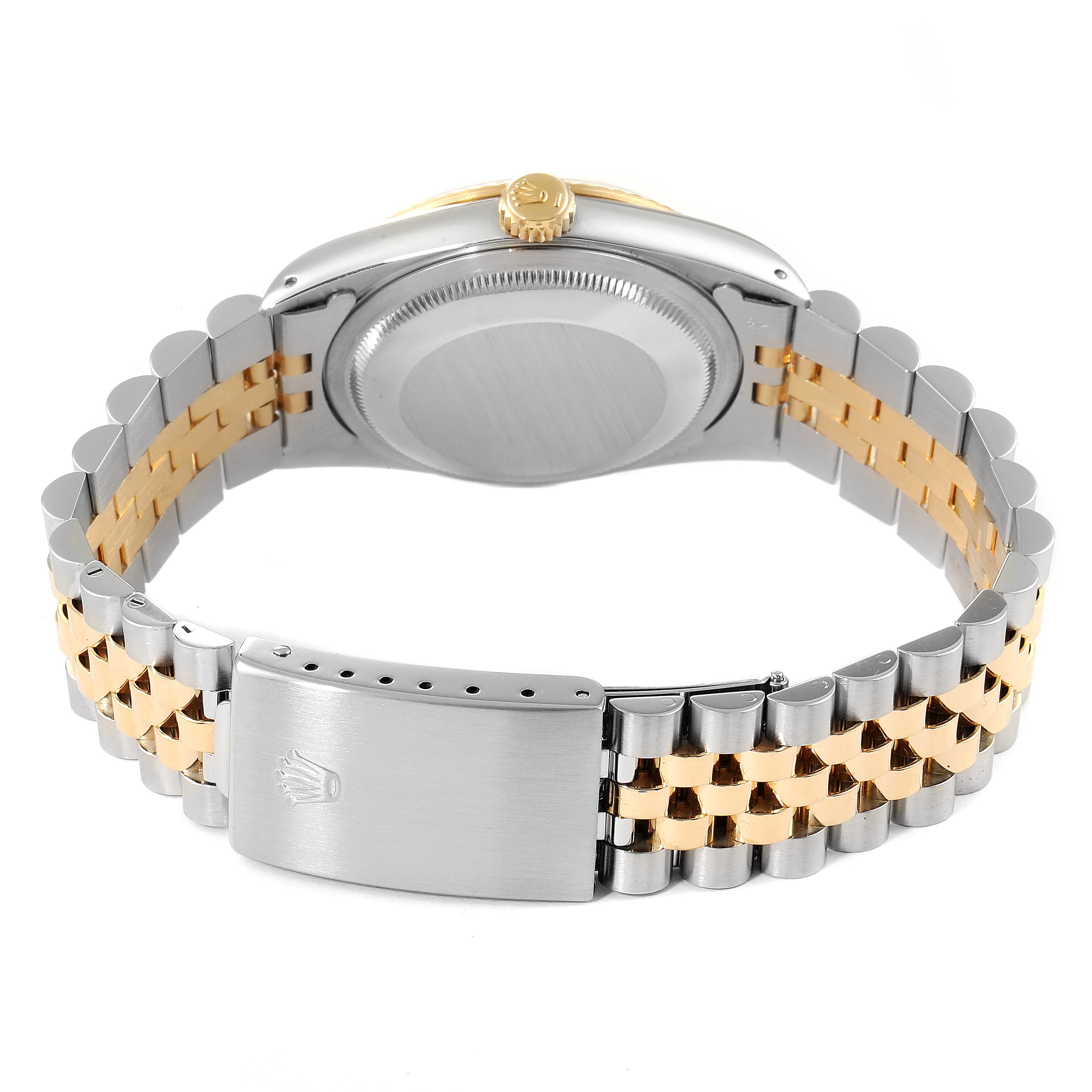 The image shows the back of a Rolex Datejust 16233 Men's Steel and Gold (two tone) White Dial 16233 Men's Steel and Gold (two tone) White Dial watch, highlighting its case back, crown, and two-tone bracelet with the clasp.