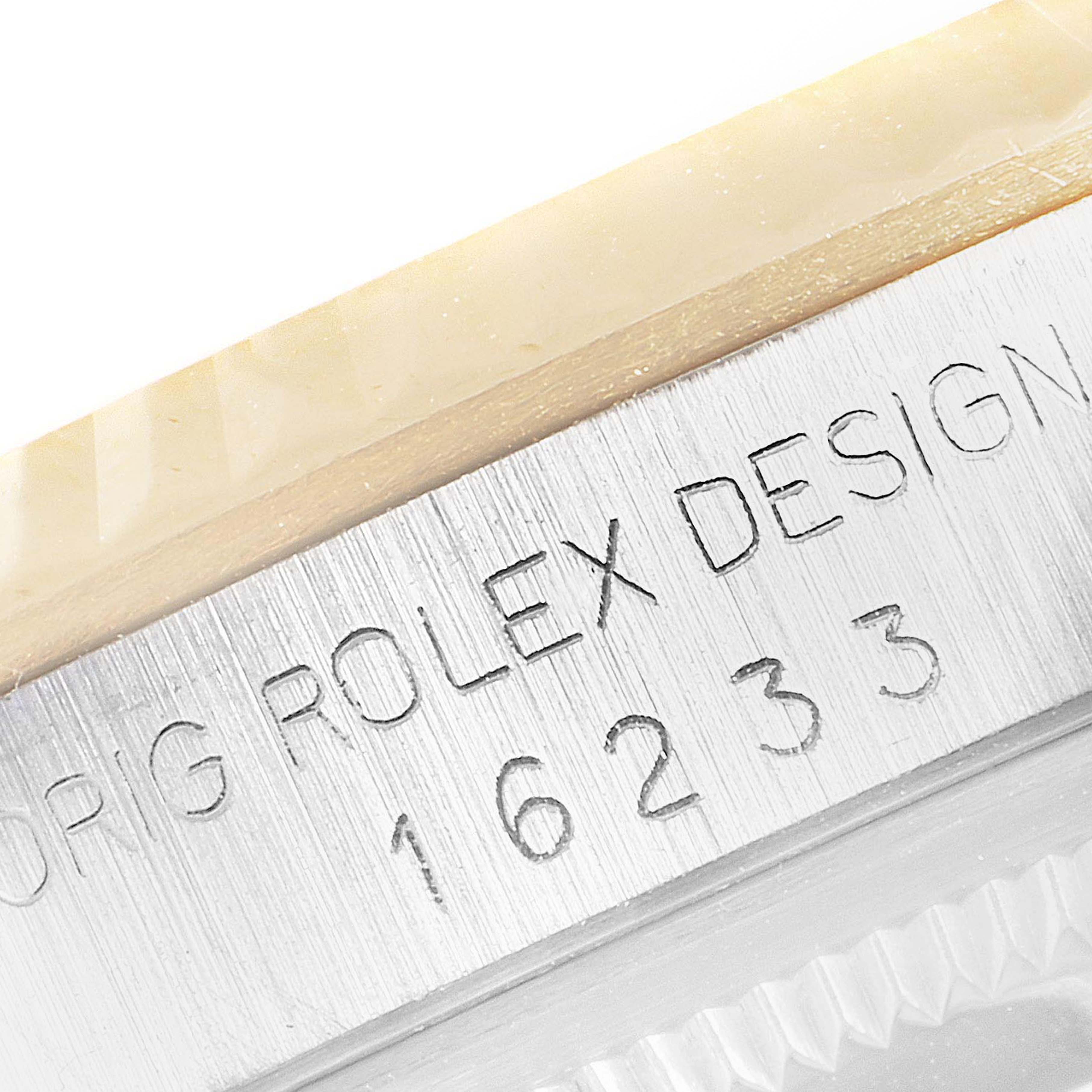 This image shows a close-up of the engraved model number and part of the bezel of a Rolex Datejust 16233 Men's Steel and Gold (two tone) White Dial 16233 Men's Steel and Gold (two tone) White Dial watch.