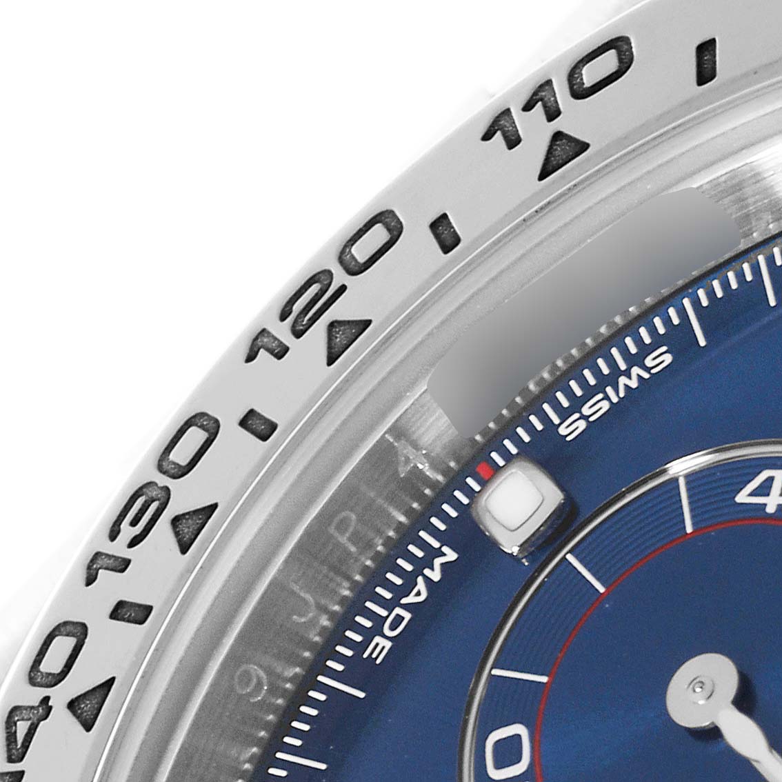 This image shows a close-up of the bezel and part of the dial of the Rolex Daytona 116509 Men's White Gold Blue Dial 116509 Men's White Gold Blue Dial watch.
