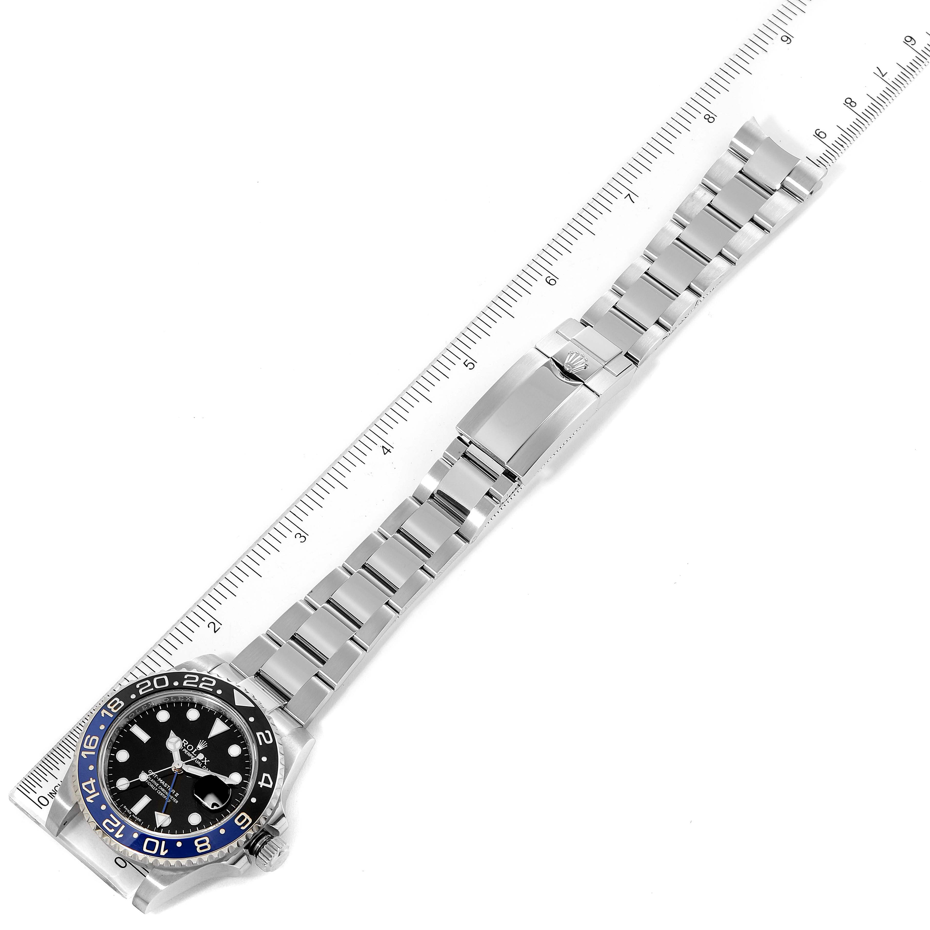 The Rolex GMT-Master 116710 Men
s Stainless Steel Black Dial 116710 Men
s Stainless Steel Black Dial watch is shown laying flat with the face-up view, band, bezel, and clasp visible alongside a ruler for scale.