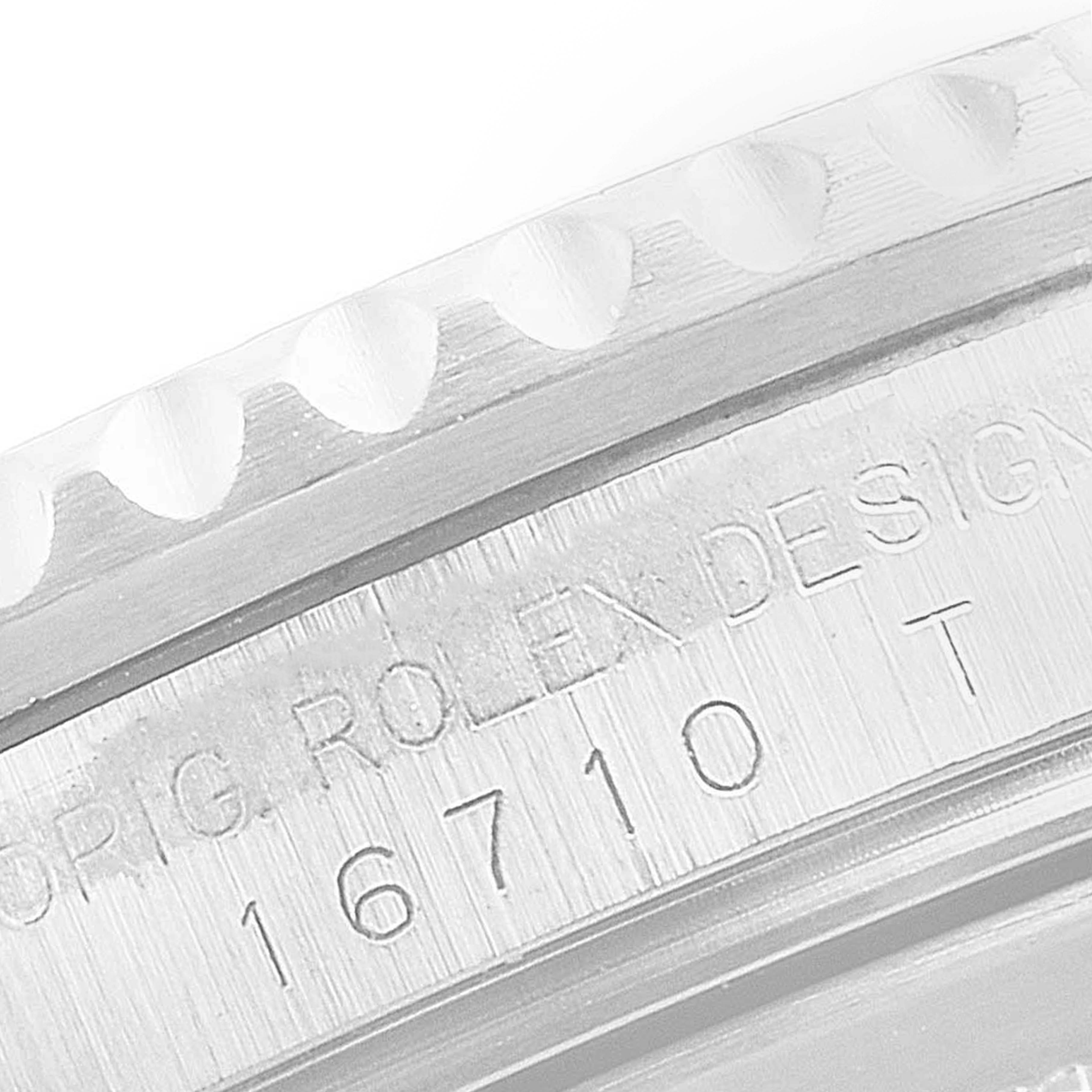 This close-up image shows the engraved model number and part of the bezel of the Rolex GMT-Master 16710 Men's Stainless Steel Black Dial 16710 Men's Stainless Steel Black Dial.