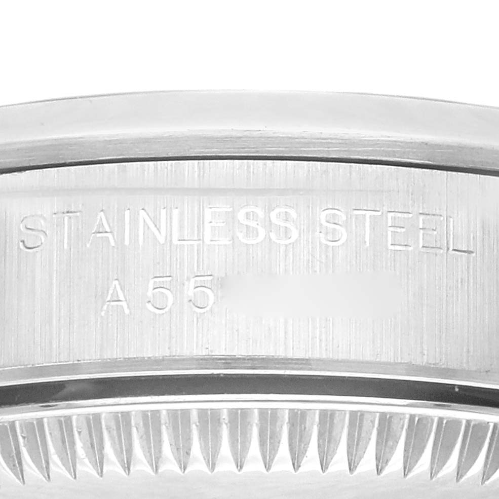 This image shows a close-up of the side of the bezel and case back with engravings on a Rolex Oyster Perpetual 76080 Women's Stainless Steel Pink Dial 76080 Women's Stainless Steel Pink Dial watch.