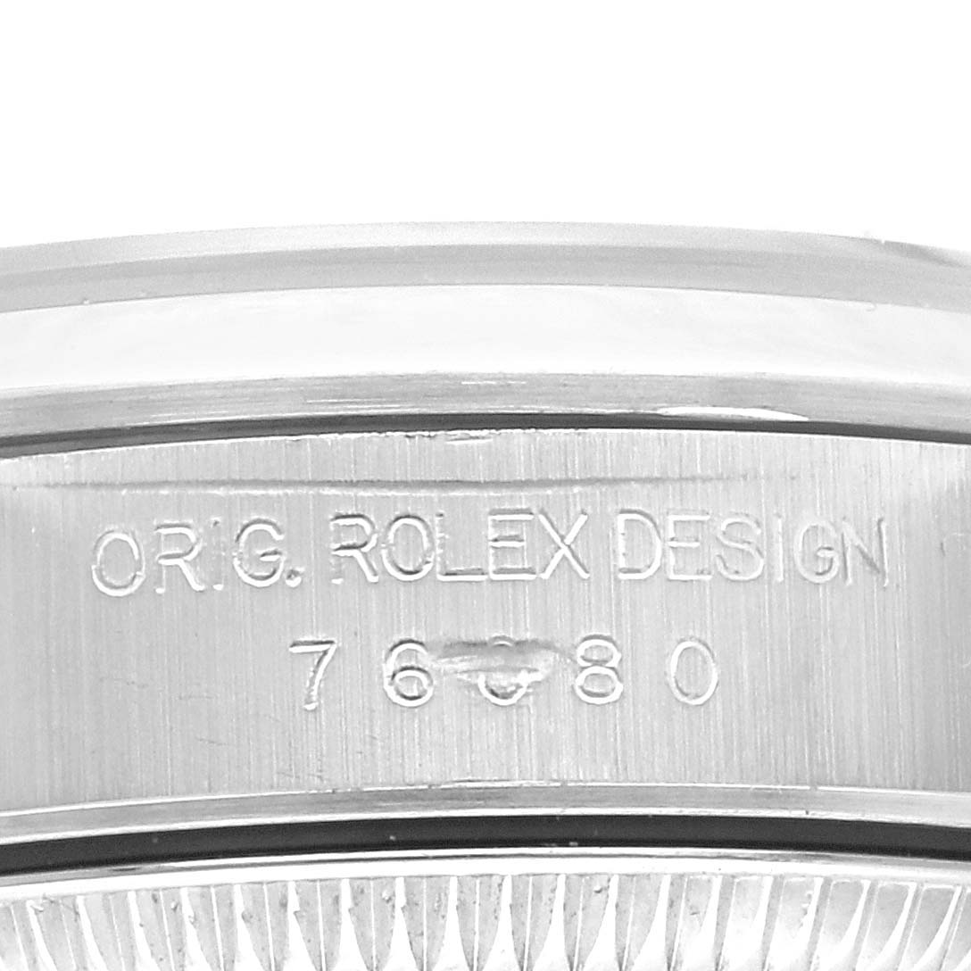 This image shows a close-up of the case side of the Rolex Oyster Perpetual 76080 Women's Stainless Steel Pink Dial 76080 Women's Stainless Steel Pink Dial model, revealing the engraved serial and design numbers.
