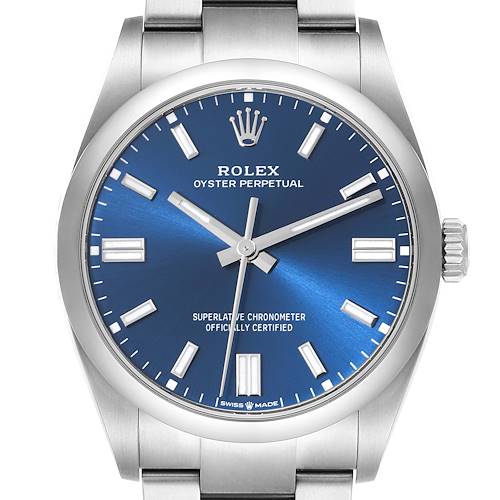 The image shows a front view of a Rolex Oyster Perpetual watch, highlighting the blue dial, hour markers, and crown.