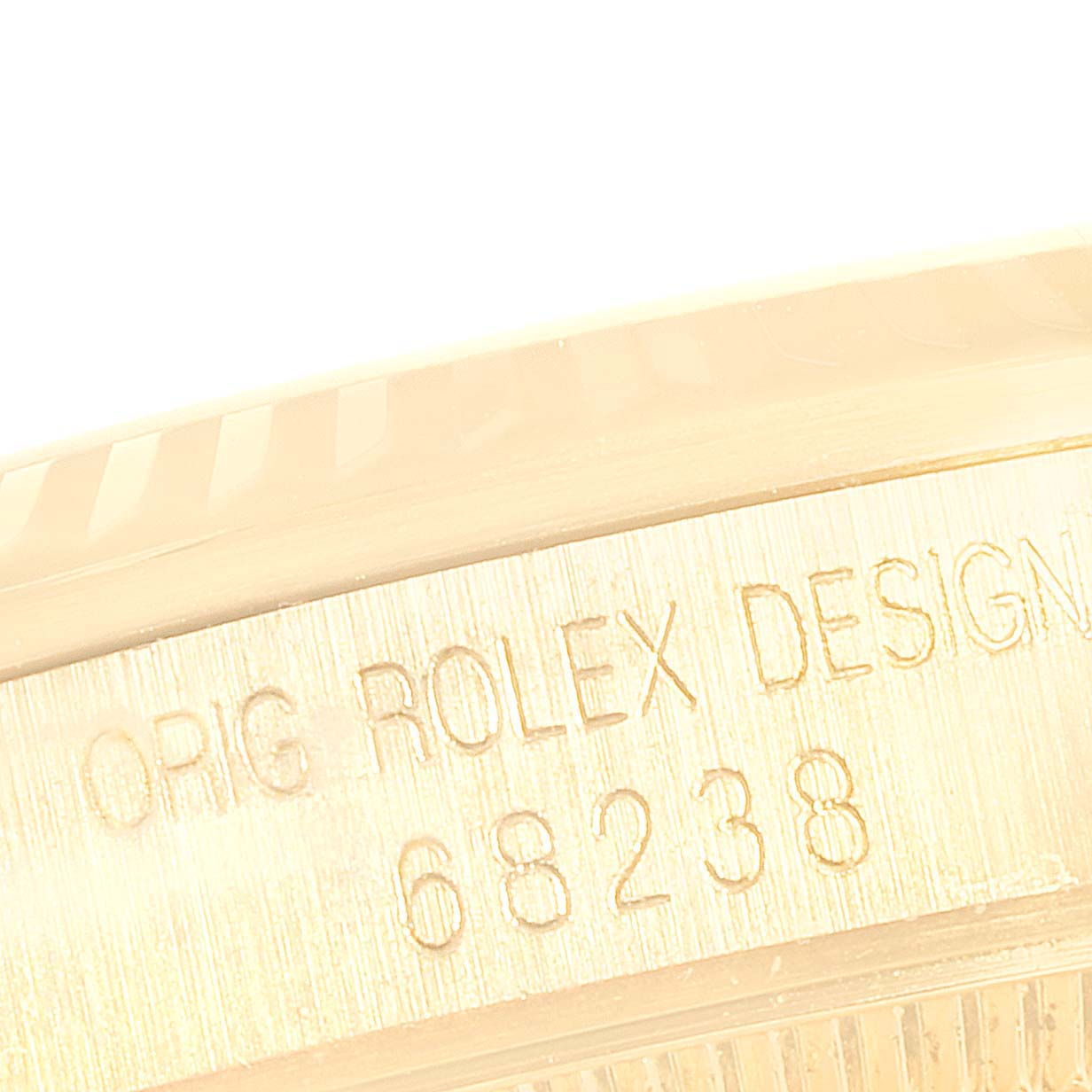 This close-up image shows the engraved side of a Rolex President 68238 Women's Yellow Gold Champagne Dial 68238 Women's Yellow Gold Champagne Dial model, highlighting "ORIG ROLEX DESIGN 68238."