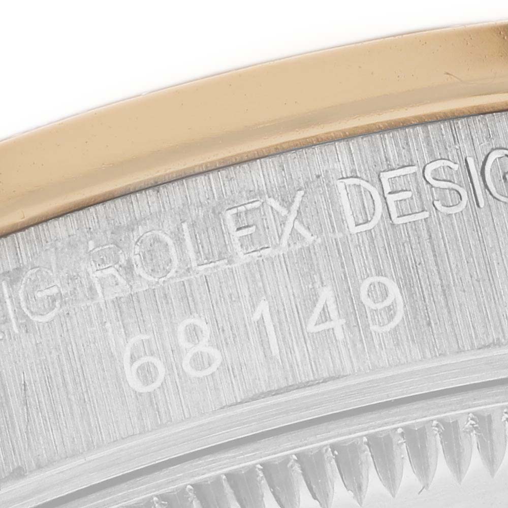 The image shows a close-up of the side of a Rolex President 68149 Women's White Gold Champagne Dial 68149 Women's White Gold Champagne Dial model, highlighting the brushed metal surface and engraved design details.