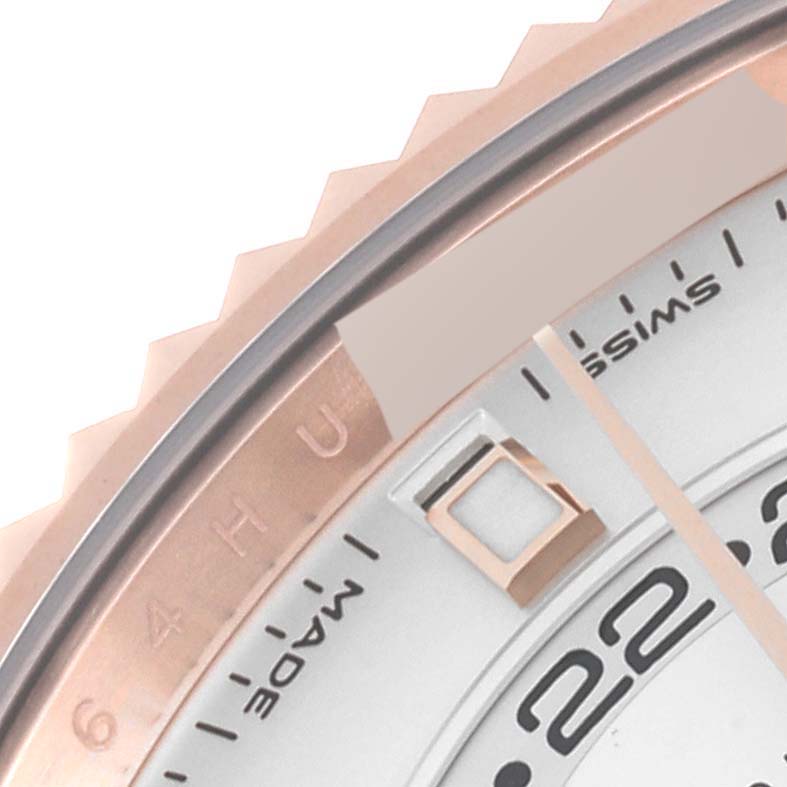 The image shows a close-up of the bezel and part of the dial of a Rolex Sky-Dweller 326235 Men's Rose Gold White Dial 326235 Men's Rose Gold White Dial watch.