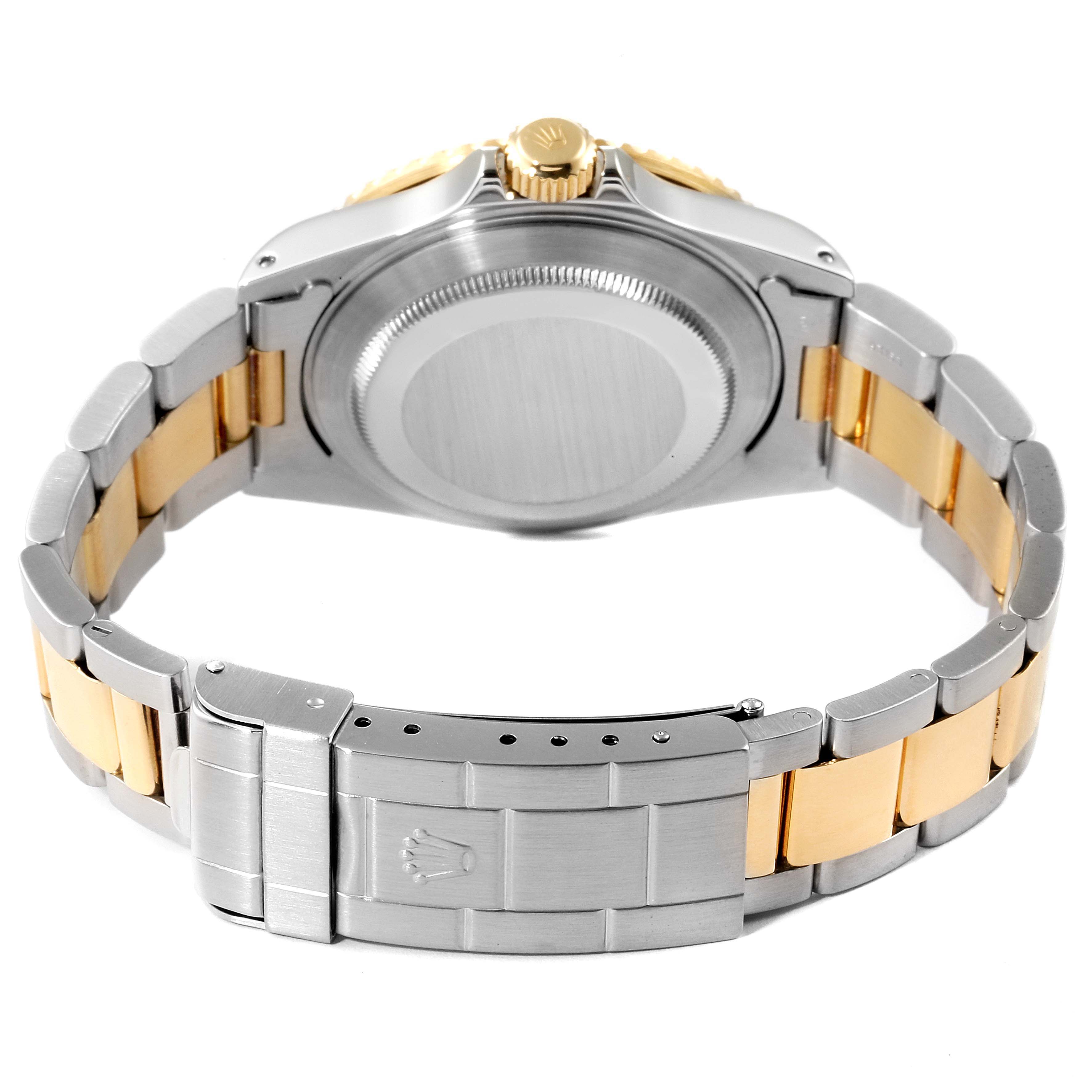 The image shows the back view of a Rolex Submariner 16613 Men's Steel and Gold (two tone) Blue Dial 16613 Men's Steel and Gold (two tone) Blue Dial watch, including its bracelet and clasp.