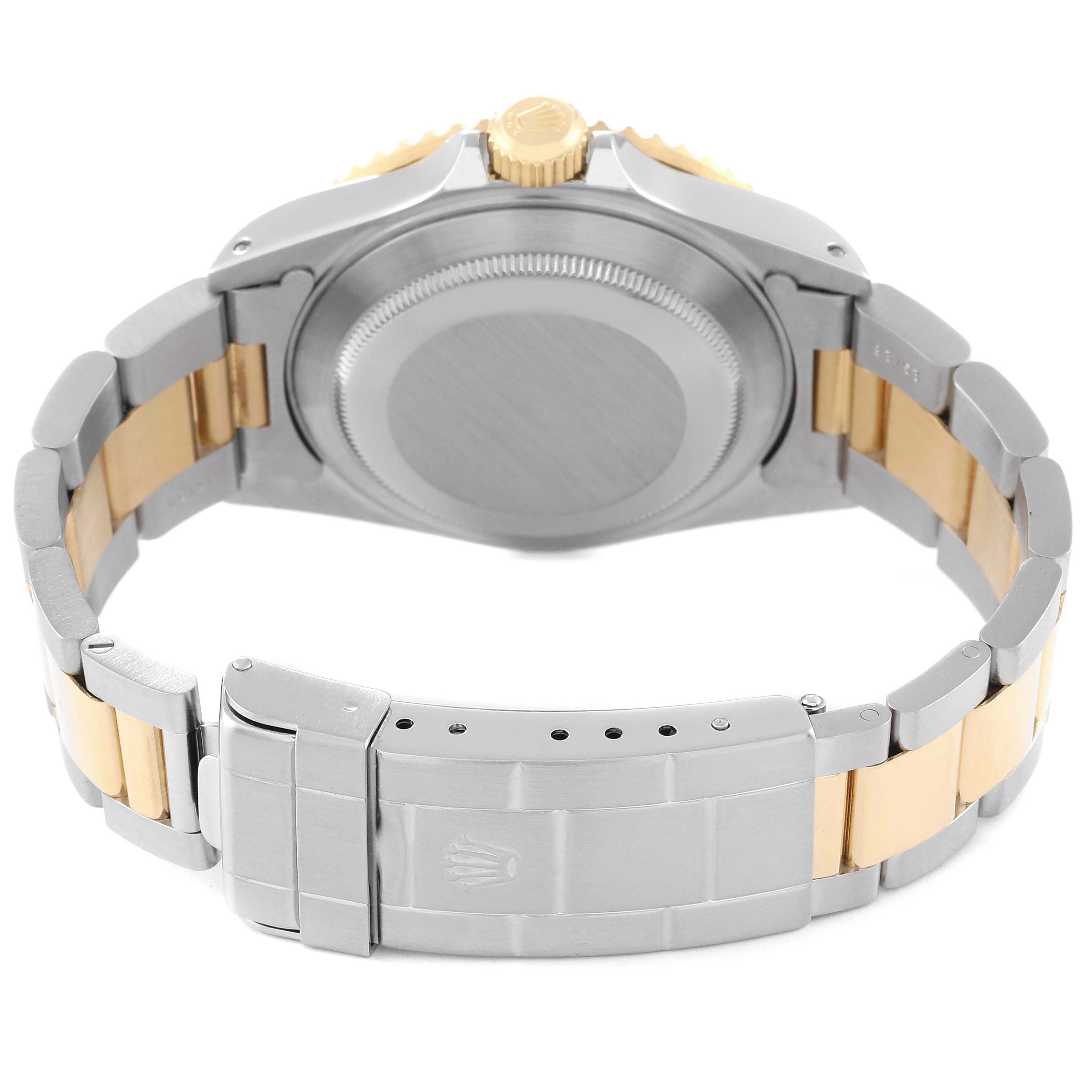 This image shows the back case and bracelet of a Rolex Submariner 16613 Men's Steel and Gold (two tone) Blue Dial 16613 Men's Steel and Gold (two tone) Blue Dial watch at an angle highlighting the two-tone metal design.