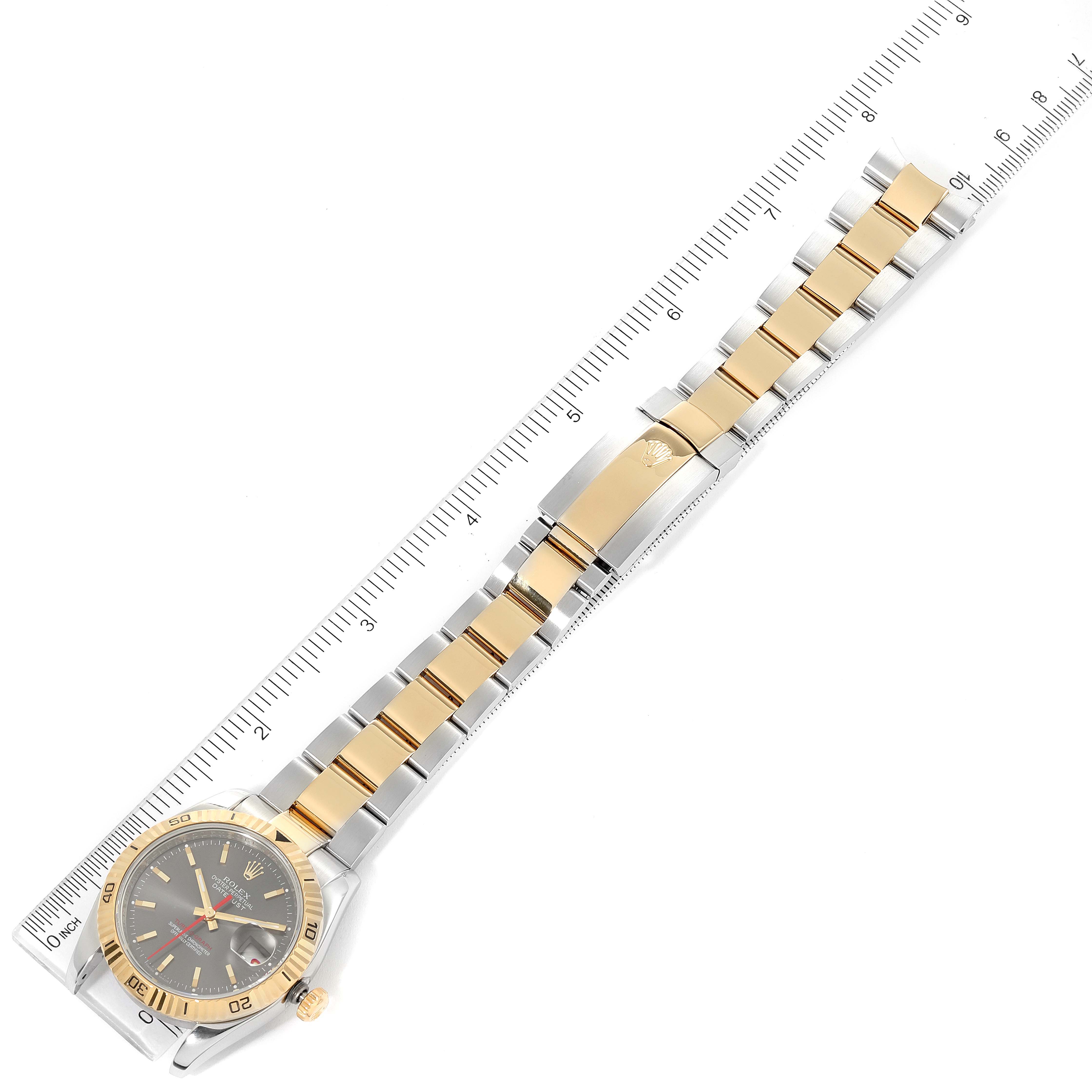 The Rolex Turn-o-Graph 116263 Men
s Steel and Gold (two tone) Grey Dial 116263 Men
s Steel and Gold (two tone) Grey Dial model watch is shown from an overhead angle, displaying the full length of the watch and the clasp.
