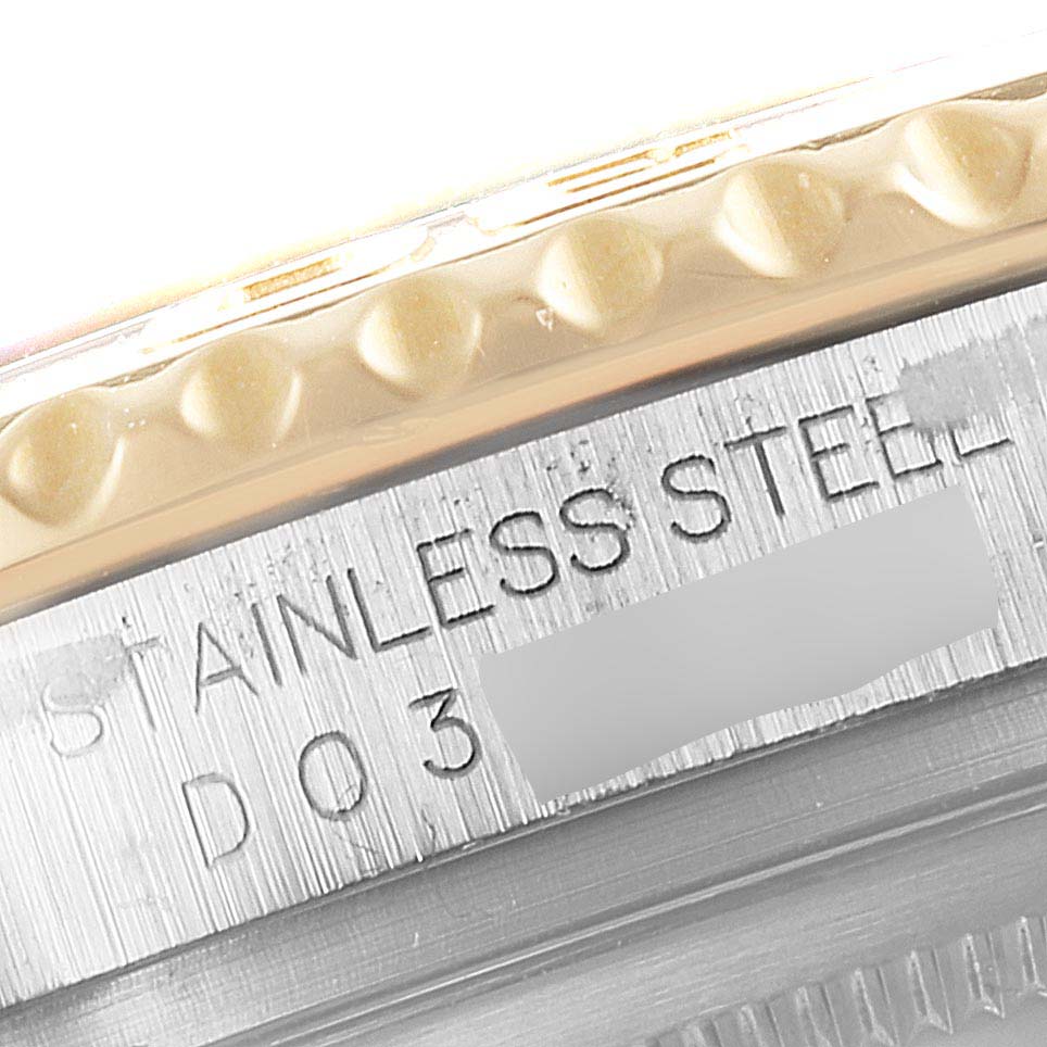 This close-up image shows the side of the bezel and caseback of a Rolex Yacht-Master 16623 Men
s Steel and Gold (two tone) White Dial 16623 Men
s Steel and Gold (two tone) White Dial, highlighting the "STAINLESS STEEL" engraving.