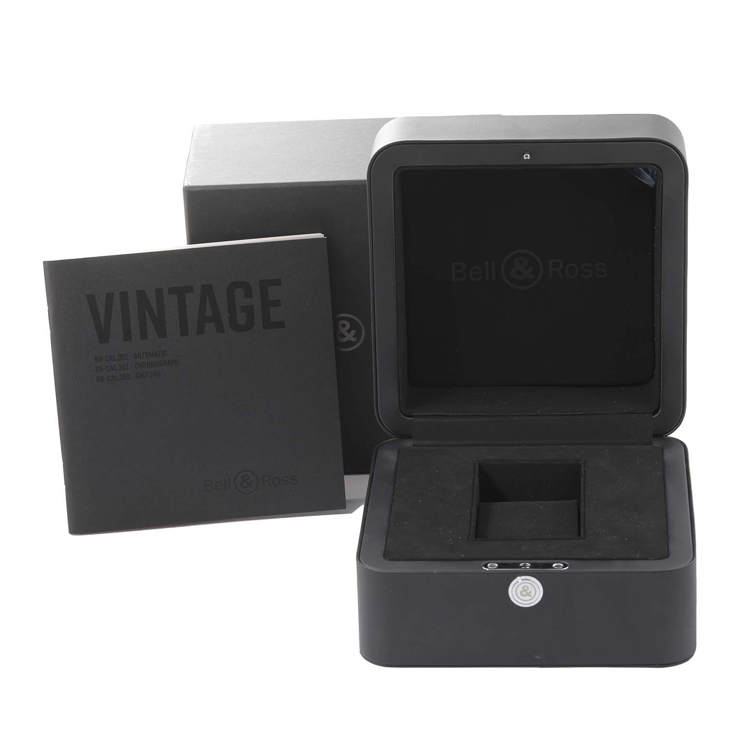 The image shows the packaging and accessories for a Bell 
Ross Heritage BRV394-BL-ST/SST Men
s Stainless Steel Black Dial BRV394-BL-ST/SST Men
s Stainless Steel Black Dial model watch, including the box and manual.