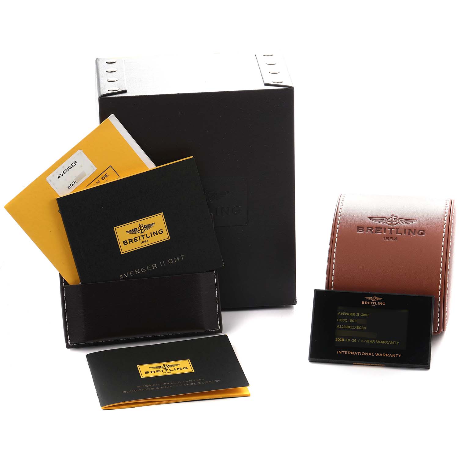 The image shows packaging and accessories for a Breitling Avenger A32390 Men
s Stainless Steel Black Dial model, including boxes, manuals, and warranty cards.