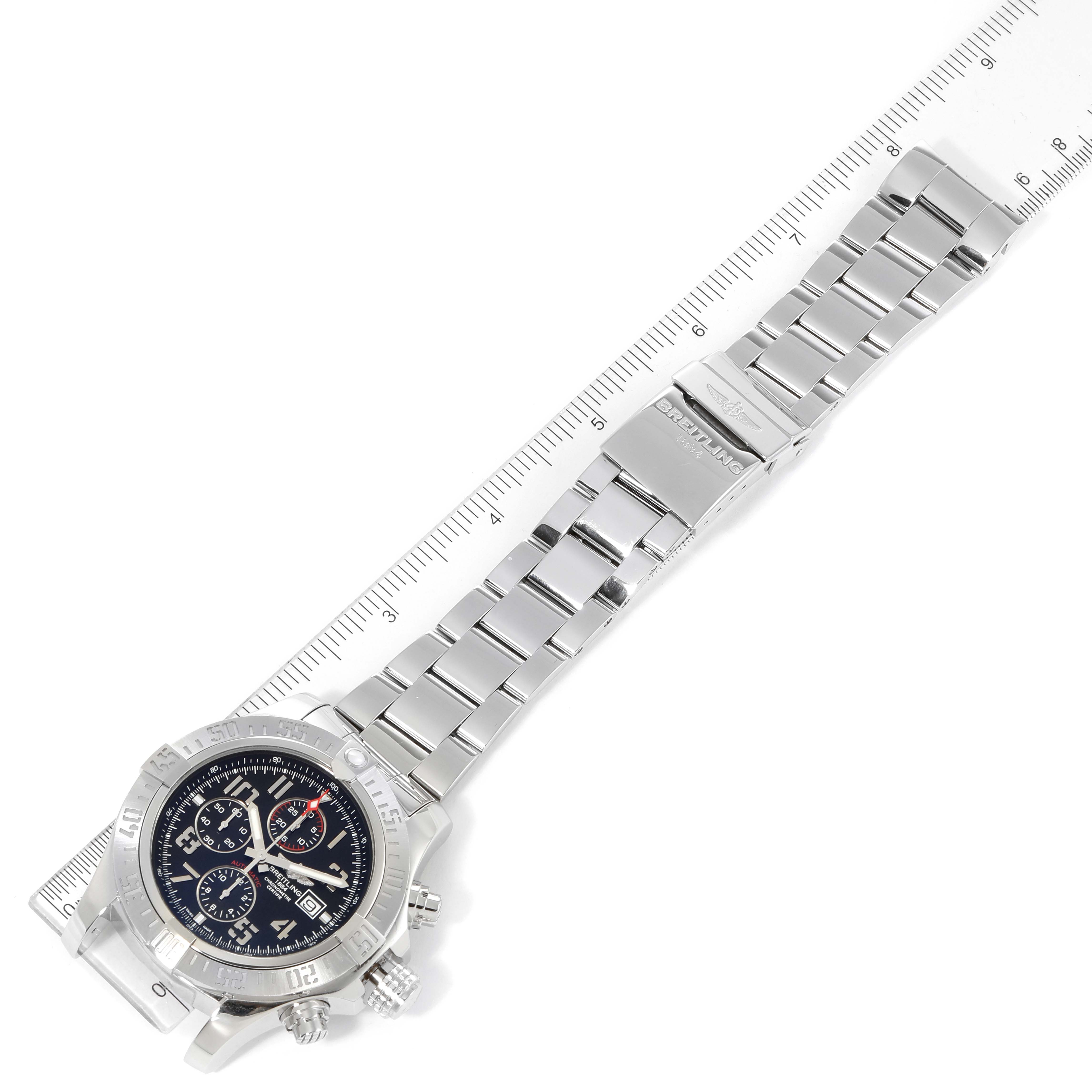 The image shows a Breitling Avenger A13371 Men's Stainless Steel Black Dial A13371 Men's Stainless Steel Black Dial watch lying flat, displaying the watch face and entire metal bracelet against a ruler.