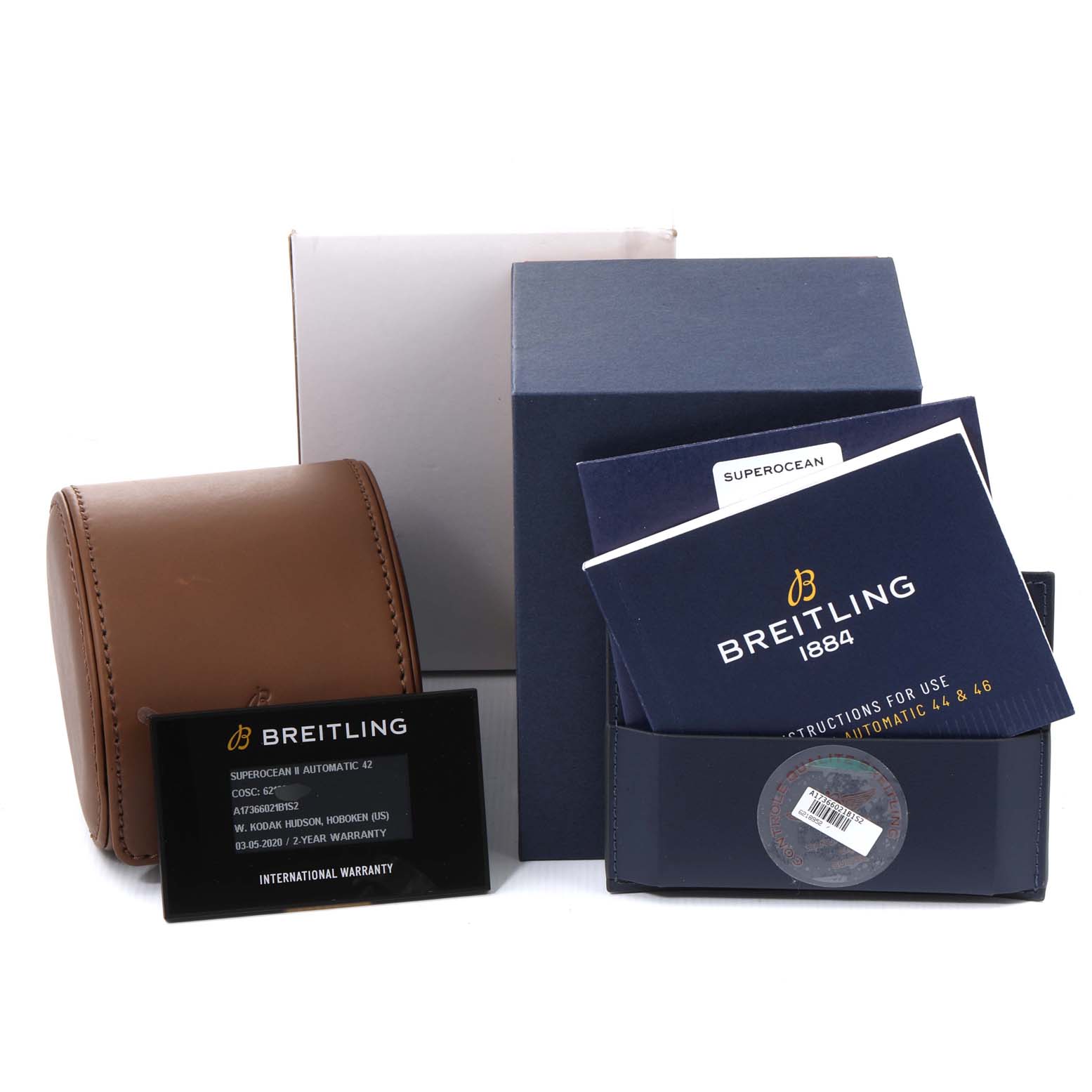 The image shows the packaging, instruction manuals, warranty card, and a travel case for a Breitling Superocean A17366 Men's Stainless Steel Black Dial A17366 Men's Stainless Steel Black Dial model watch.