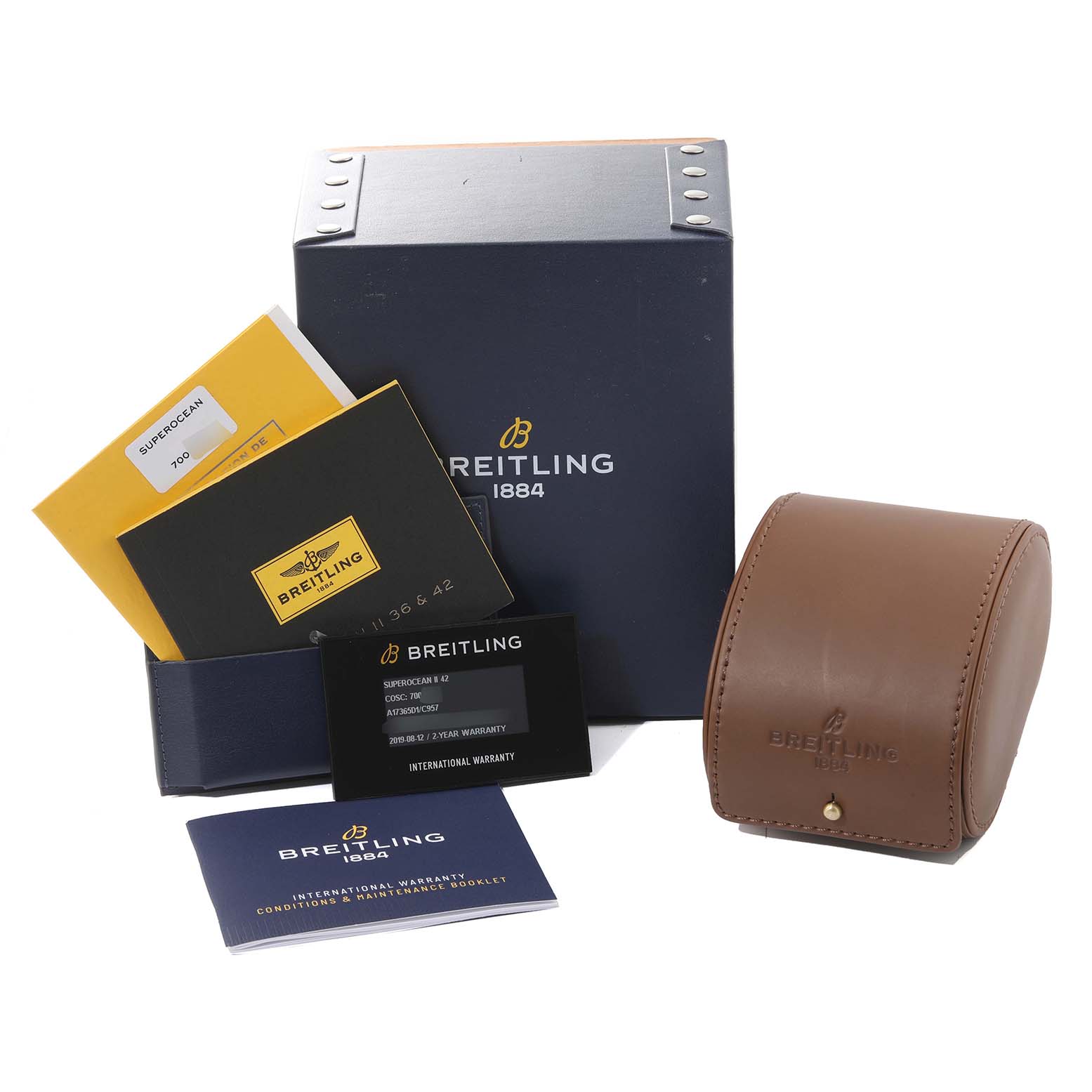 The image shows packaging and accessories for a Breitling Superocean A17365 Men
s Stainless Steel Blue Dial A17365 Men
s Stainless Steel Blue Dial watch, including a box, manuals, warranty card, and a leather case.