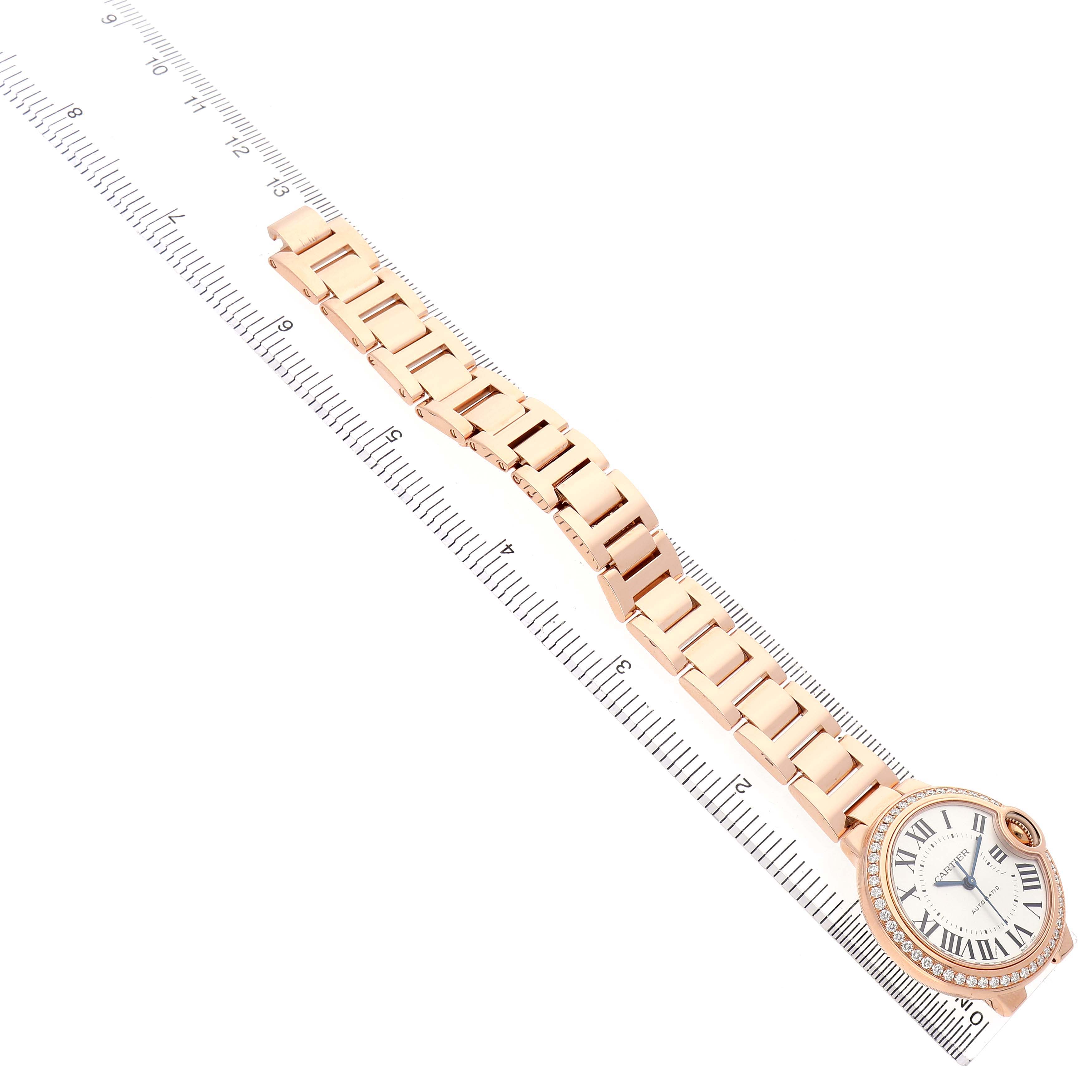 The Cartier Ballon Bleu WJBB0036 Women's Rose Gold Silver Dial watch is shown at an angle displaying the face, bracelet, and a ruler for size reference.