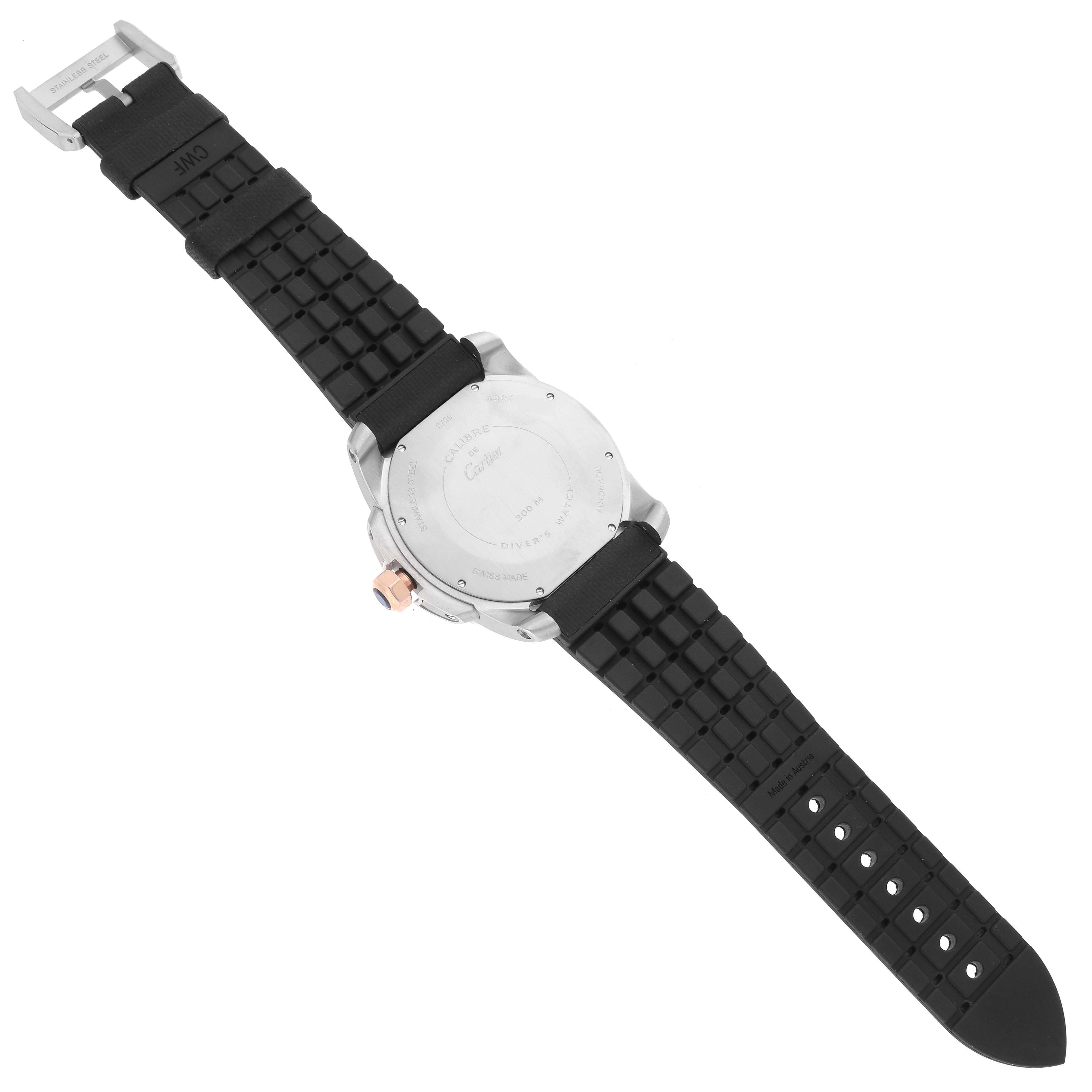 The image shows the back of a Calibre de Cartier watch by Cartier, highlighting the case back, crown, and textured black strap.