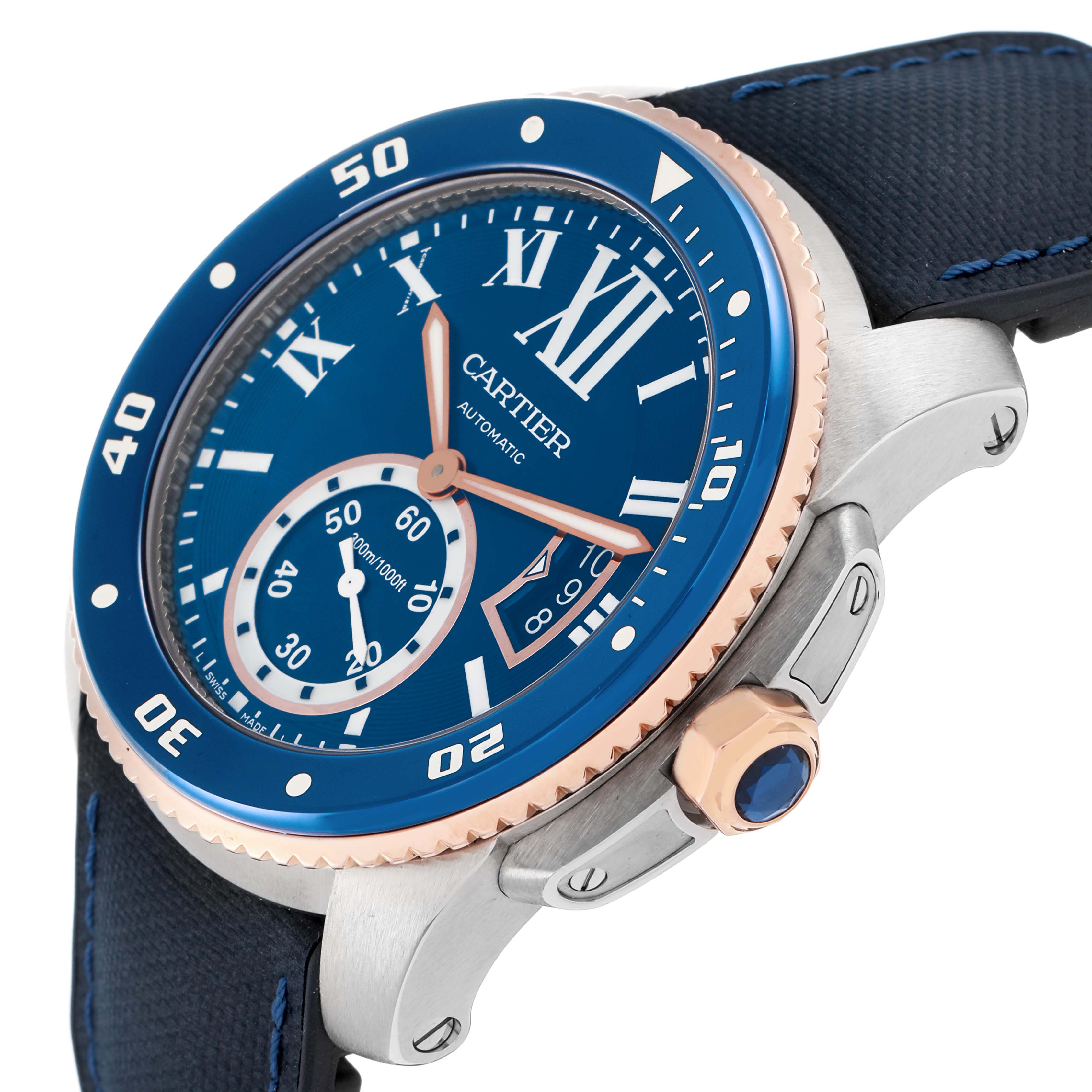The Calibre de Cartier watch is shown at an angled view, highlighting the blue dial, bezel, and crown with a portion of the strap.