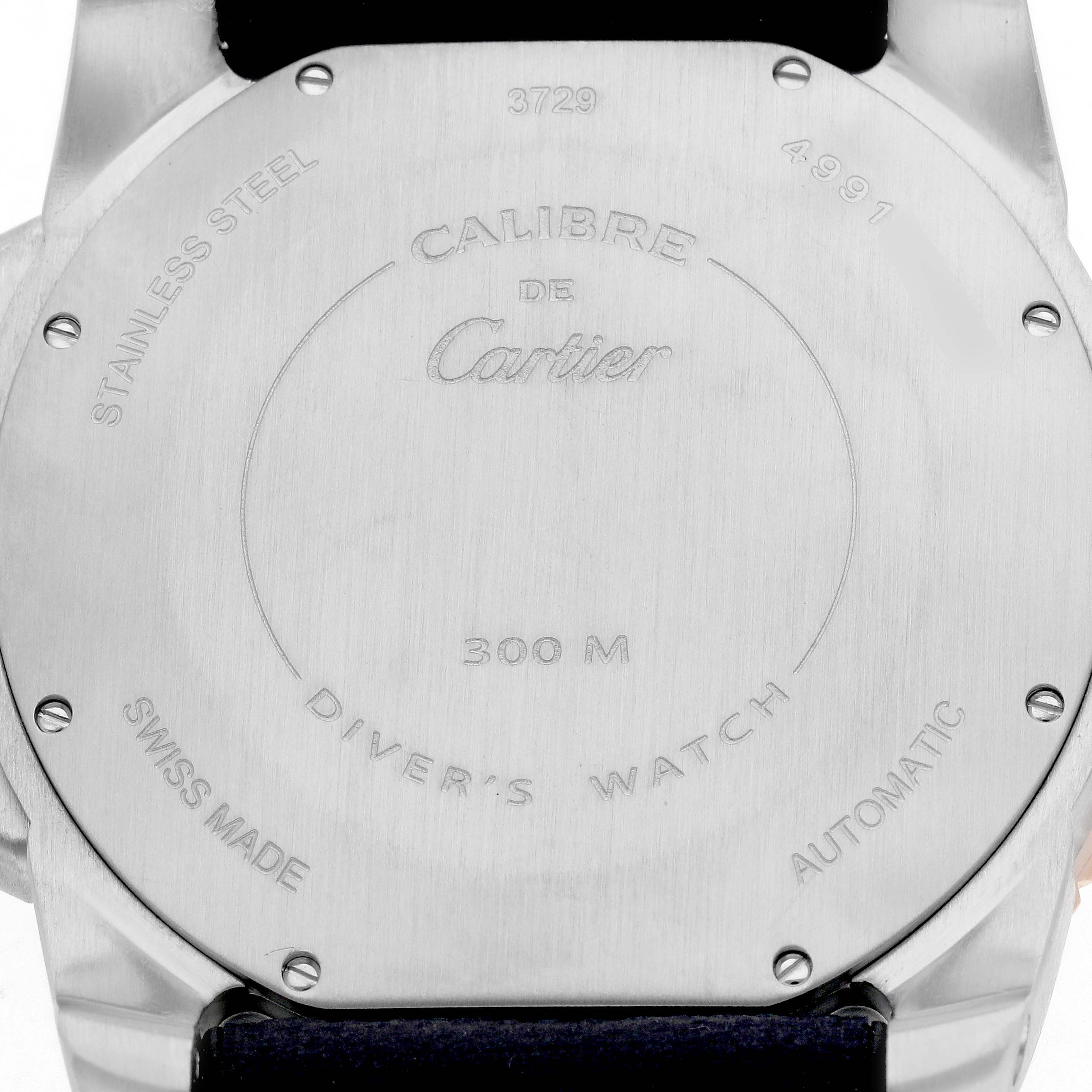 The image shows the stainless steel case back of the Calibre de Cartier watch.