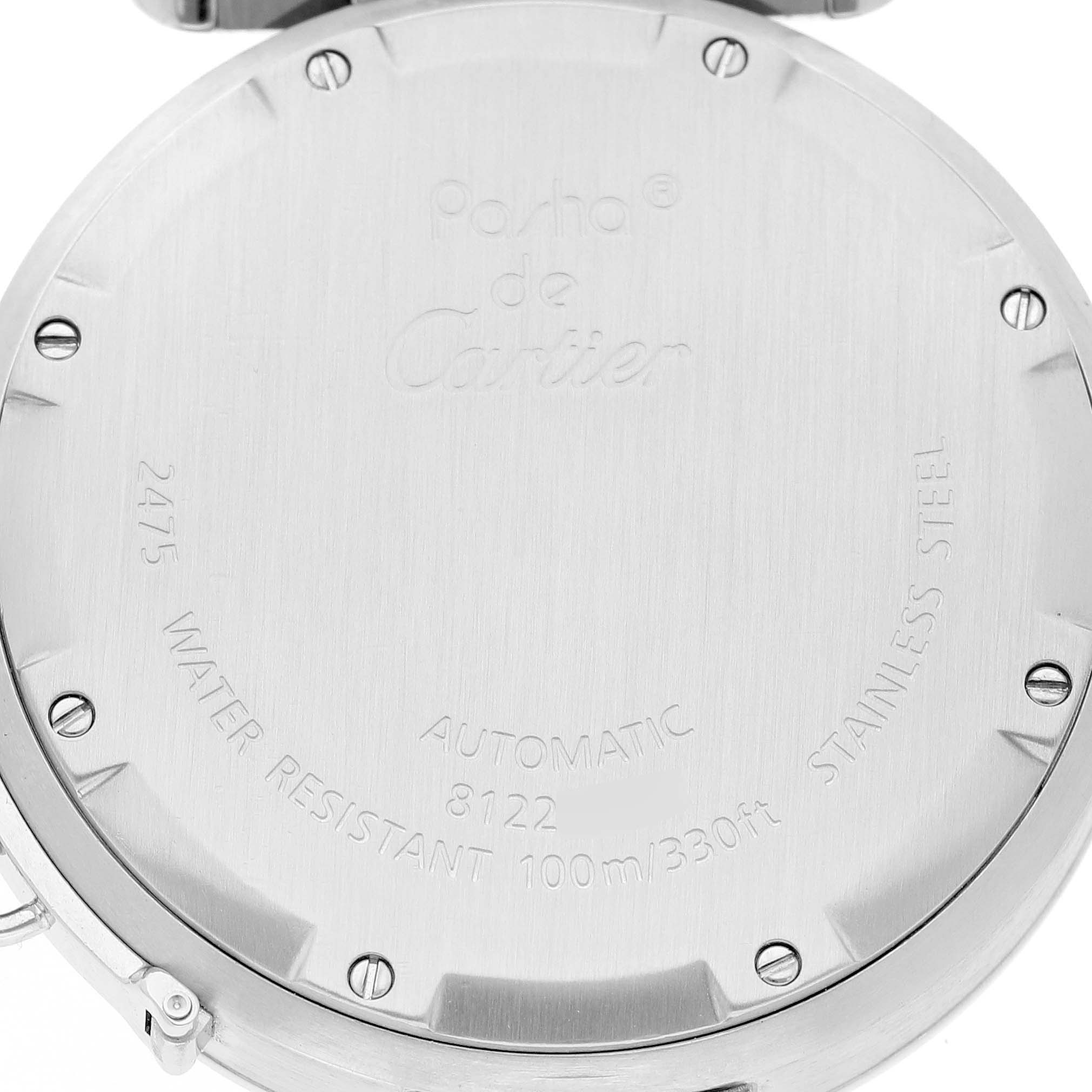 The image shows the back case of a Cartier Pasha W31058M7 Women's Stainless Steel Pink Dial watch, displaying engravings and screws.