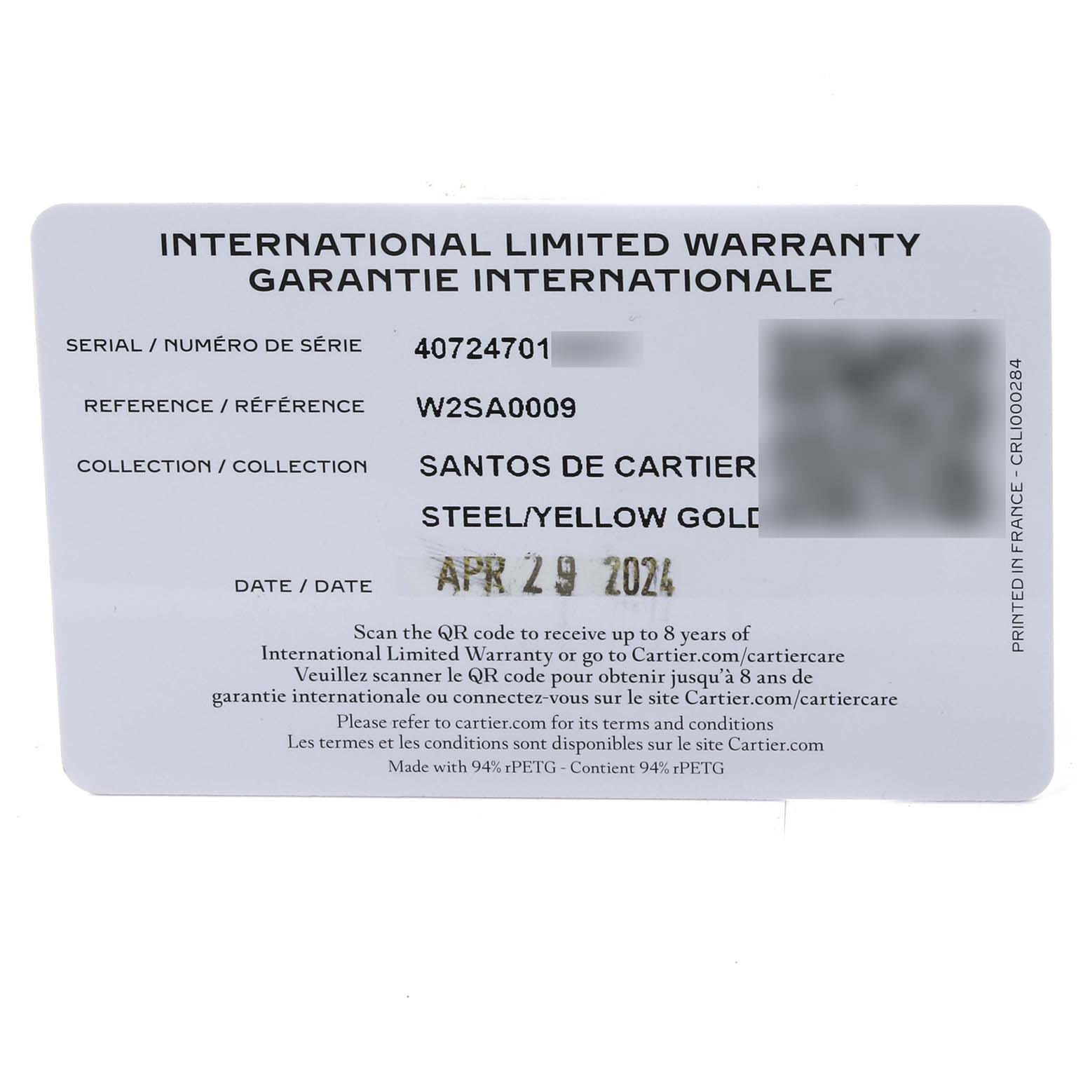 This image shows the International Limited Warranty card for the Santos de Cartier watch, model W2SA0009, in steel/yellow gold.