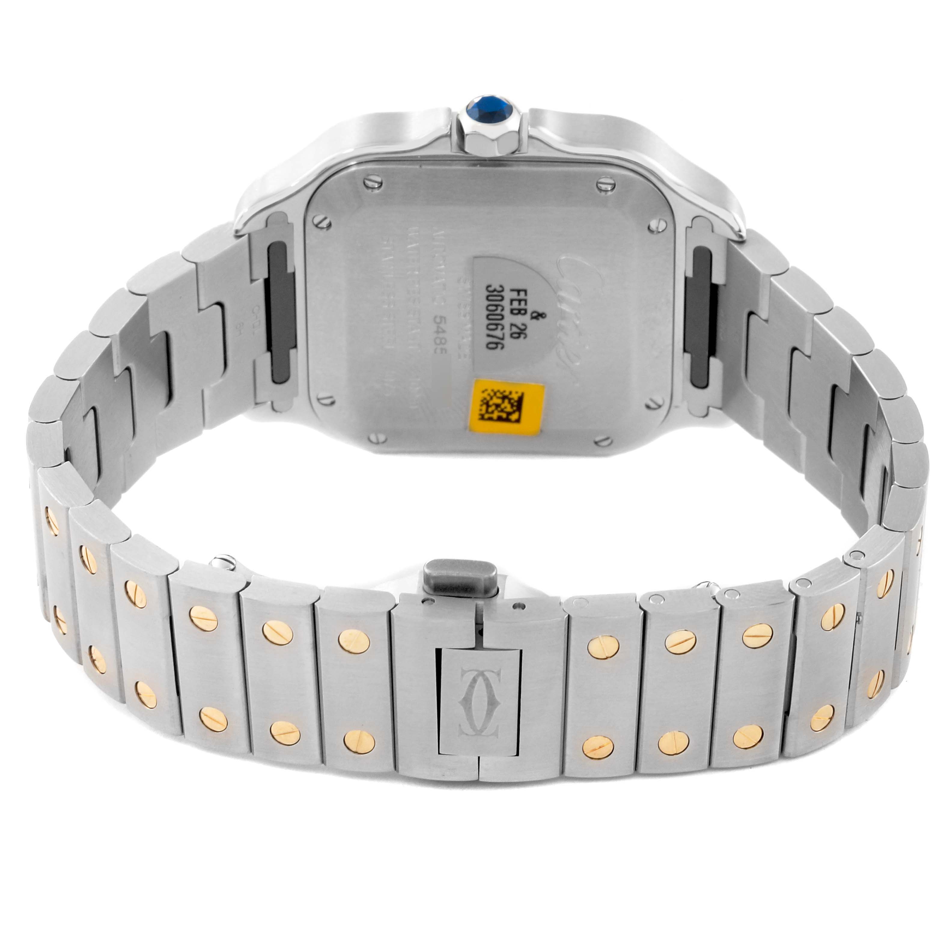 The image shows the back and bracelet of a Cartier Santos W2SA0016 Men
s Steel and Gold (two tone) Silver Dial W2SA0016 Men
s Steel and Gold (two tone) Silver Dial watch, highlighting its case back and metal bracelet with gold accents.