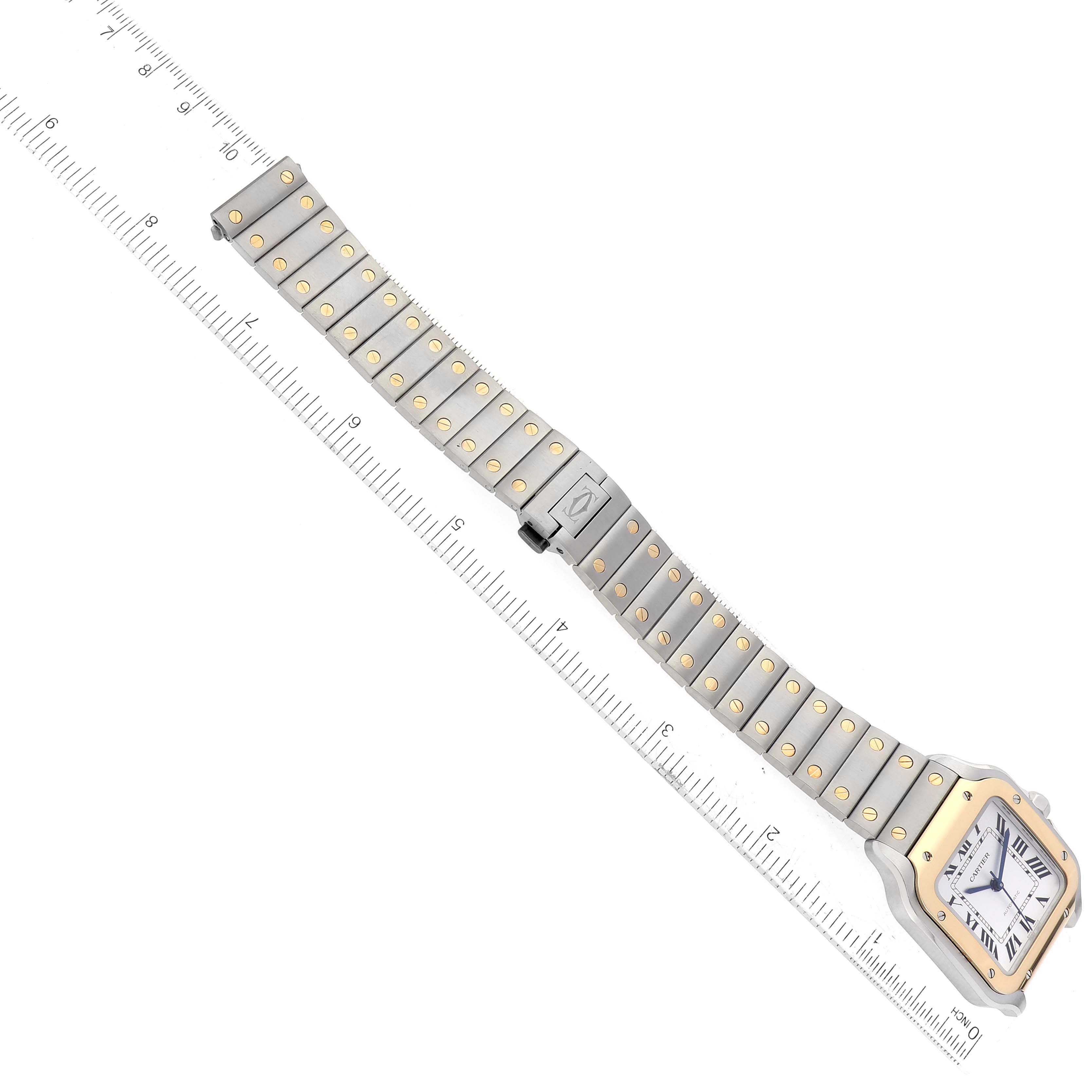 The Cartier Santos W2SA0016 Men
s Steel and Gold (two tone) Silver Dial W2SA0016 Men
s Steel and Gold (two tone) Silver Dial watch is shown from a top-down angle, highlighting the entire bracelet and face with a ruler for scale.