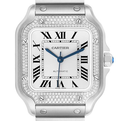 The Cartier Santos W4SA0005 Men's Stainless Steel Silver Dial watch is shown from a front angle, highlighting its diamond-encrusted bezel, Roman numeral dial, and blue hands.