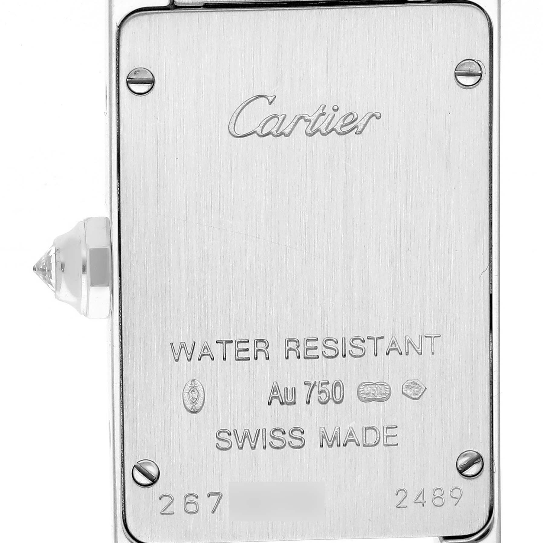 The image shows the back case of a Cartier Tank Américaine watch, including the brand name, water resistance, and Swiss Made markings.