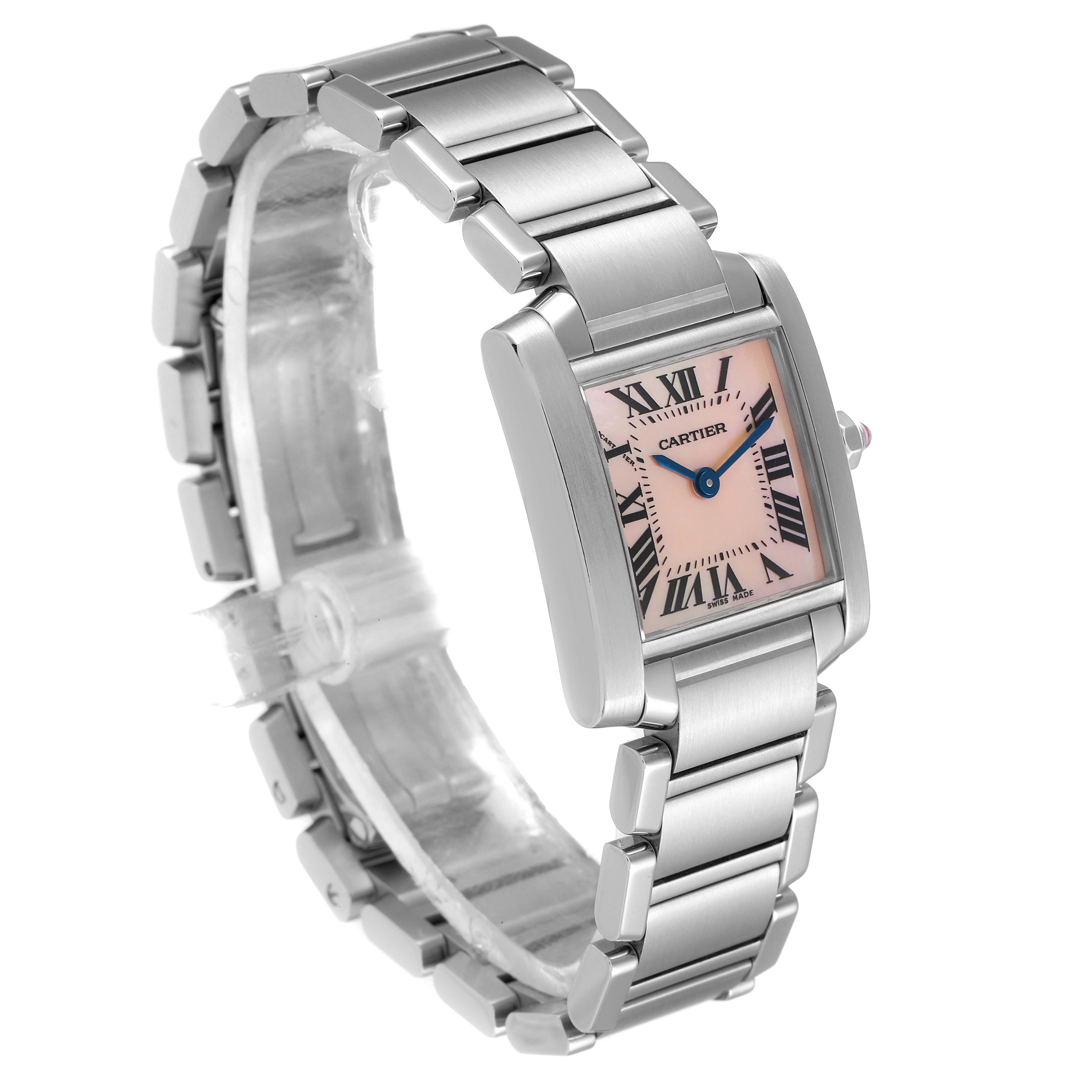 The image shows a Tank Francaise Cartier watch at a slight angle, highlighting the pink dial, Roman numerals, and metal bracelet.