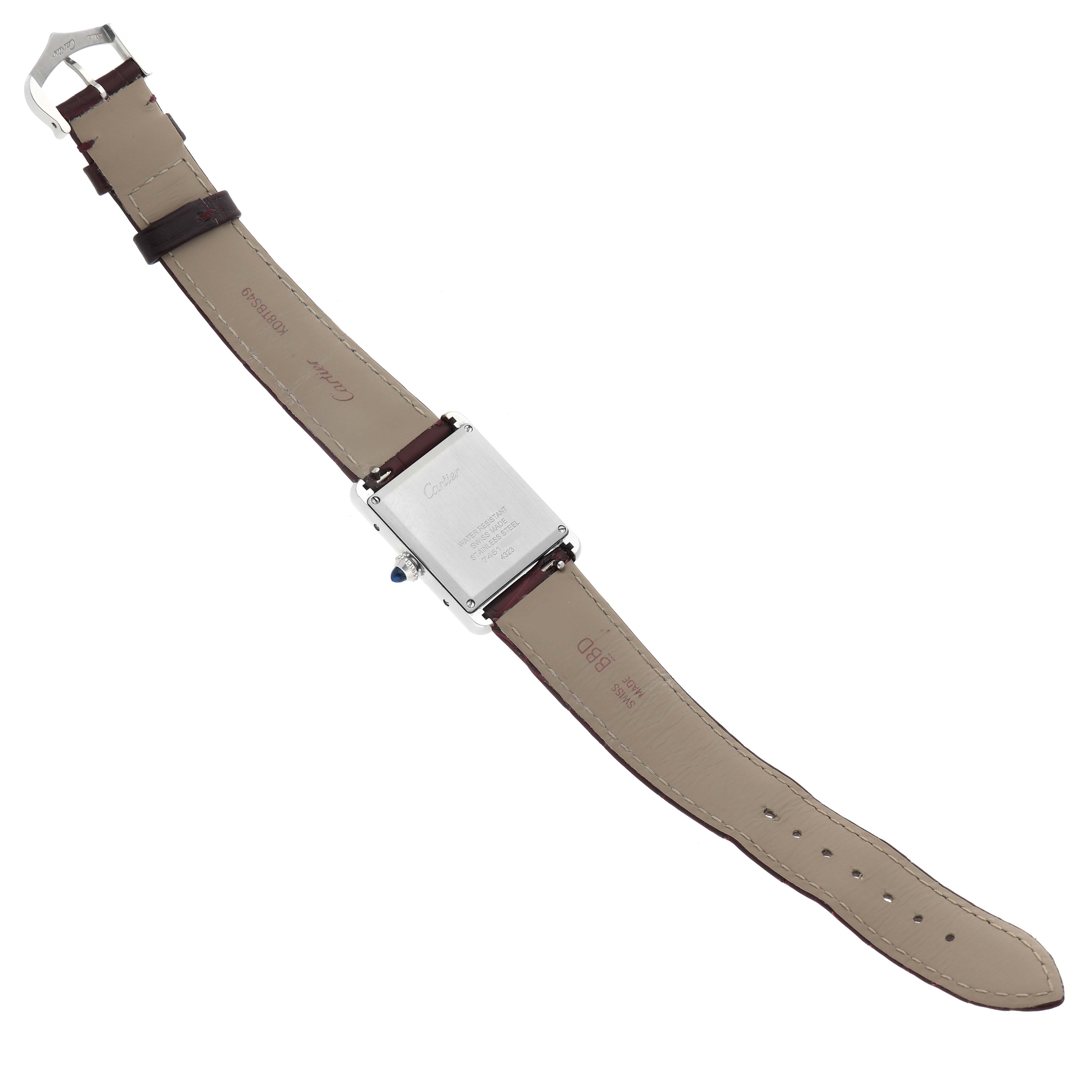 The image shows the back view of a Cartier Tank Must WSTA0054 Women's Stainless Steel Red Dial WSTA0054 Women's Stainless Steel Red Dial watch, including the strap and case back.