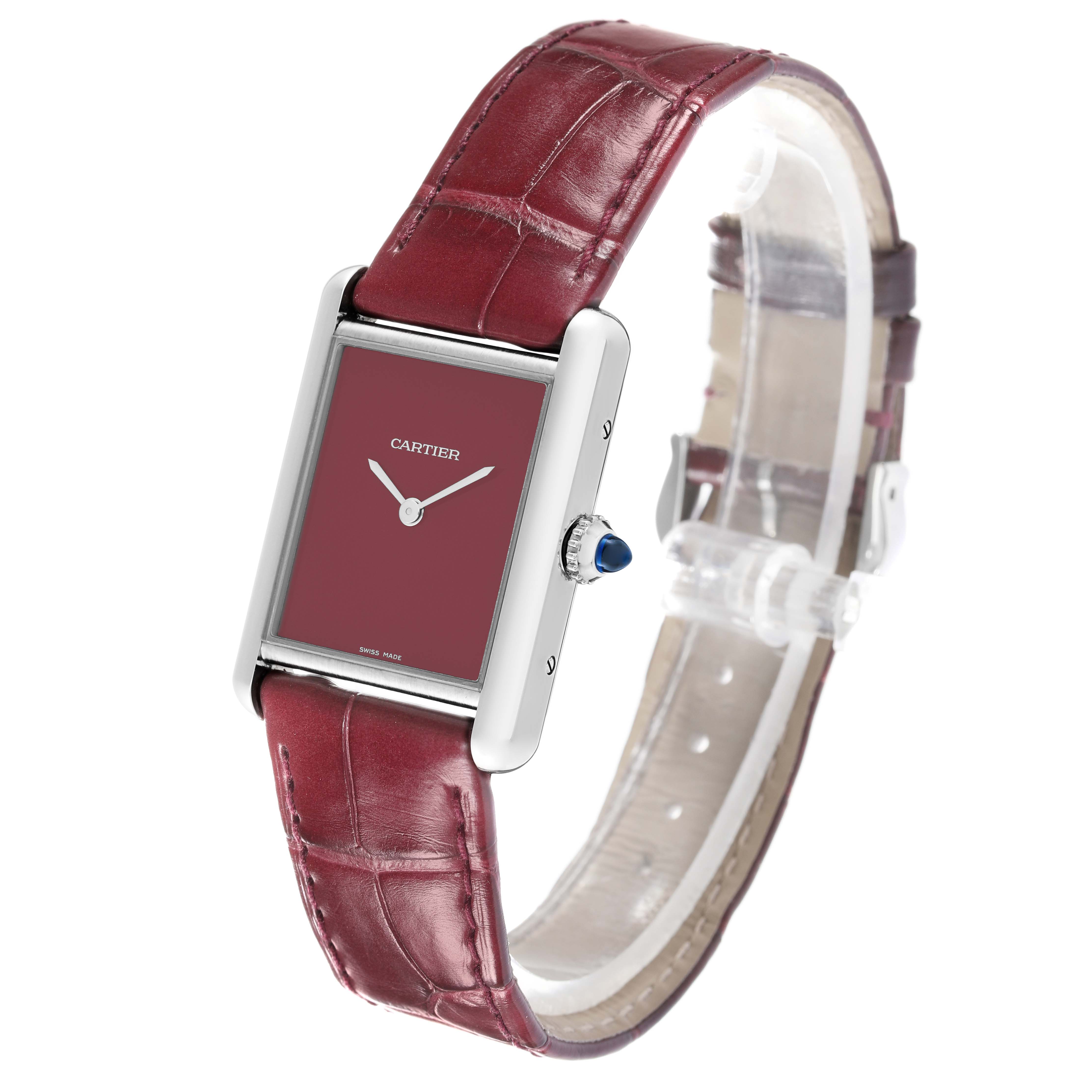 The Cartier Tank Must WSTA0054 Women's Stainless Steel Red Dial WSTA0054 Women's Stainless Steel Red Dial watch is shown at a three-quarter angle, highlighting the face, crown, and burgundy leather strap.