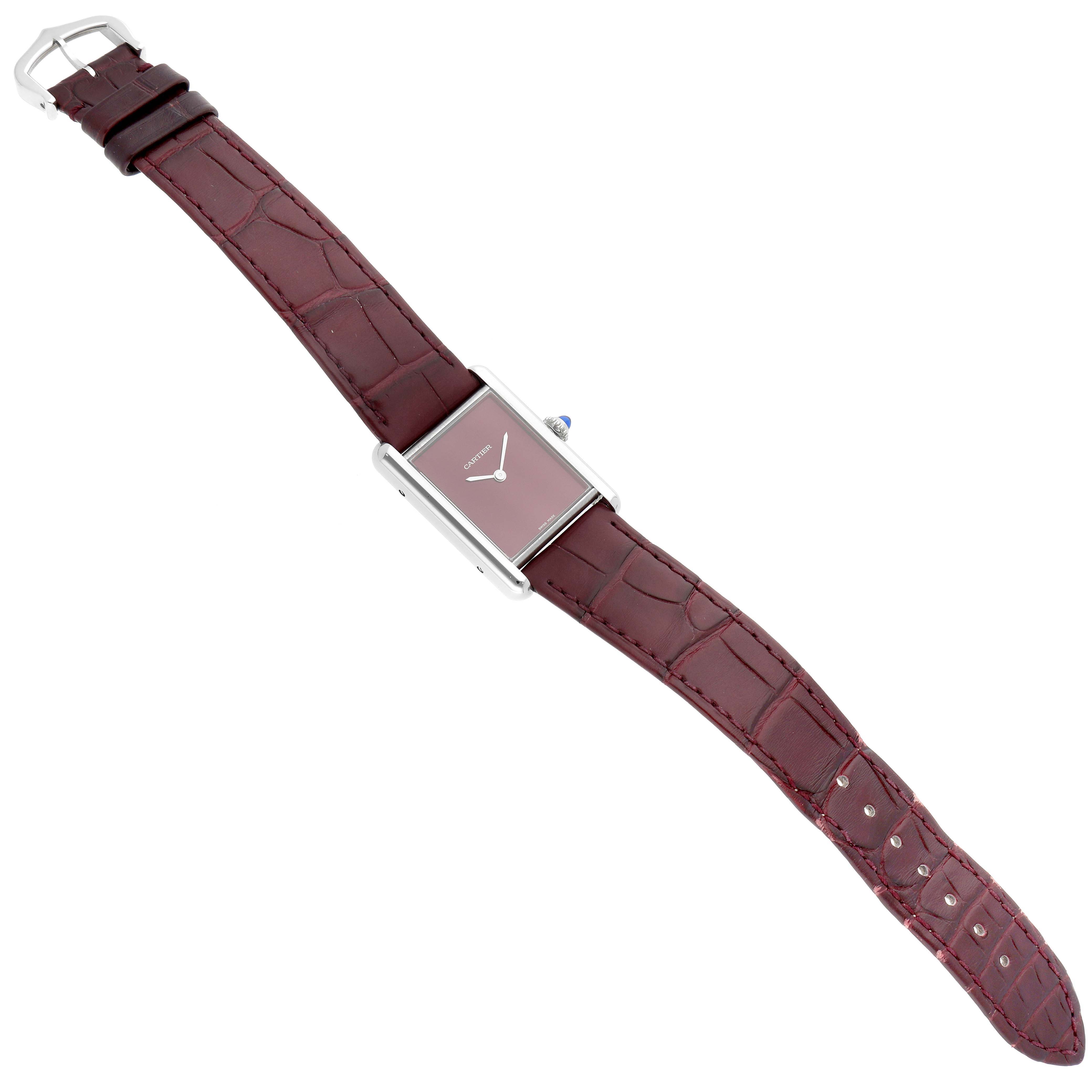 This Cartier Tank Must WSTA0054 Women's Stainless Steel Red Dial WSTA0054 Women's Stainless Steel Red Dial watch is shown from a top view, featuring a rectangular case, burgundy dial, and matching leather strap.