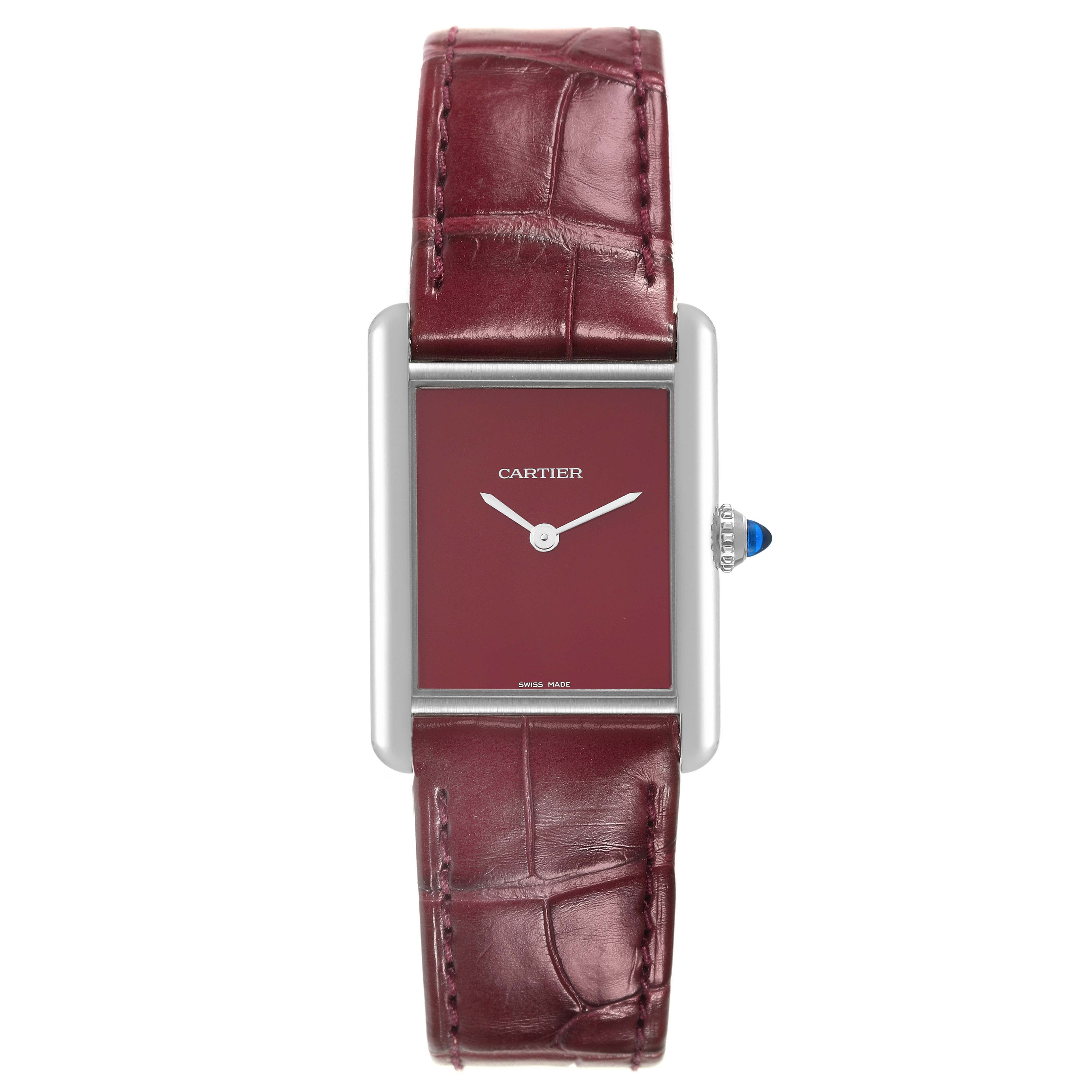 The image shows a front view of the Cartier Tank Must WSTA0054 Women's Stainless Steel Red Dial WSTA0054 Women's Stainless Steel Red Dial watch, highlighting its red dial, silver hands, and burgundy leather strap.